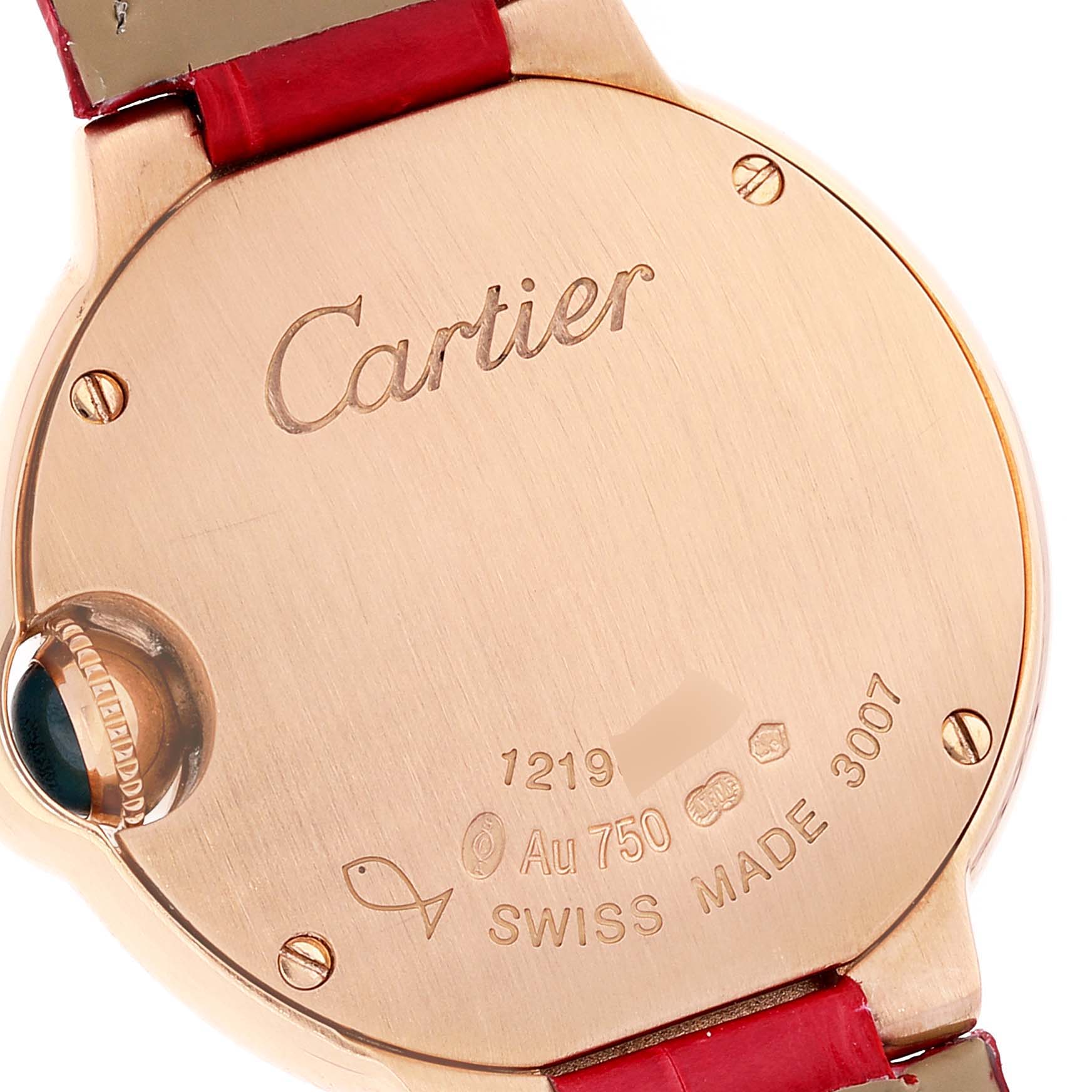 The image shows the back casing of a Ballon Bleu de Cartier watch with engravings and a red strap attachment.