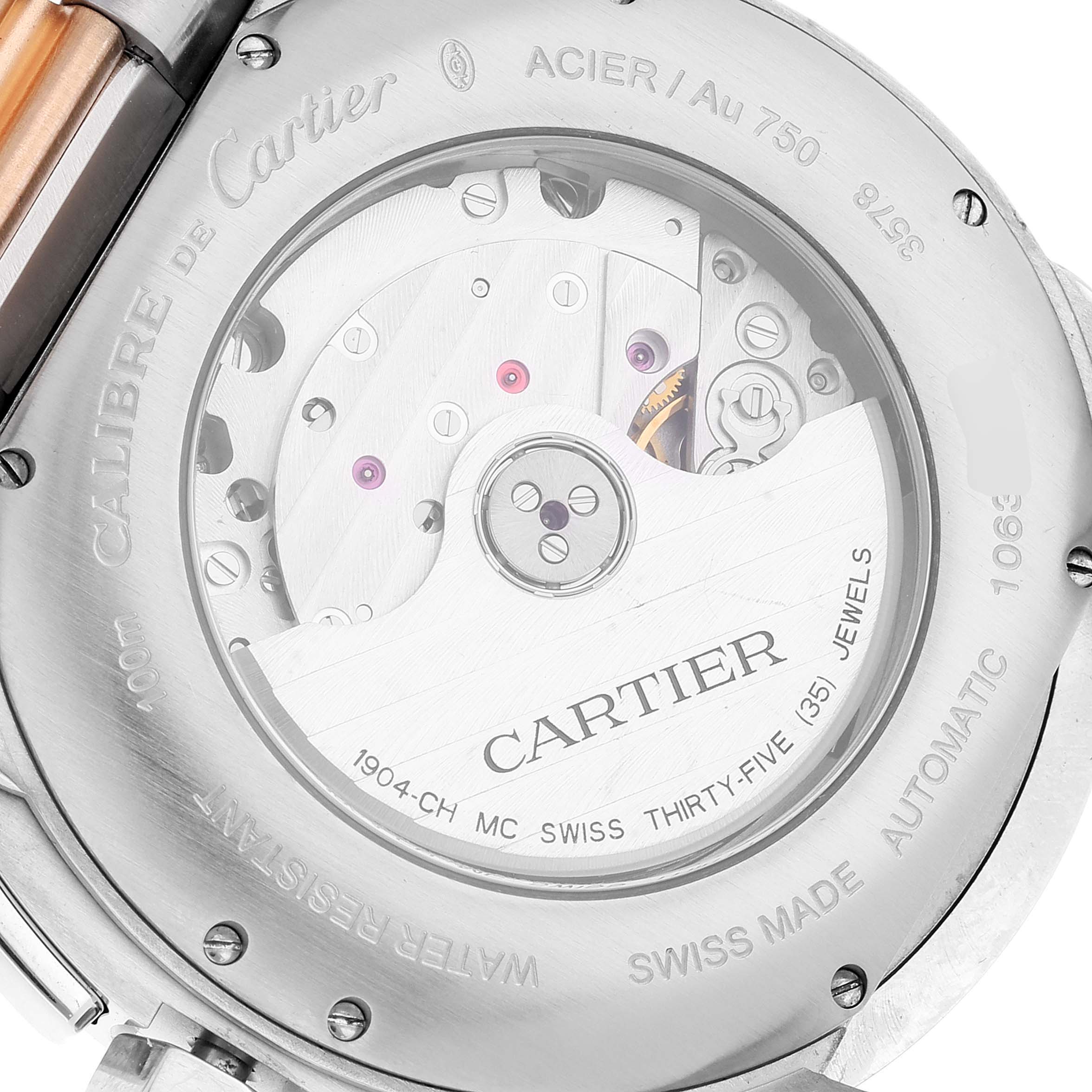 The image shows the back of a Calibre de Cartier model by Cartier, revealing the automatic movement and inscriptions.