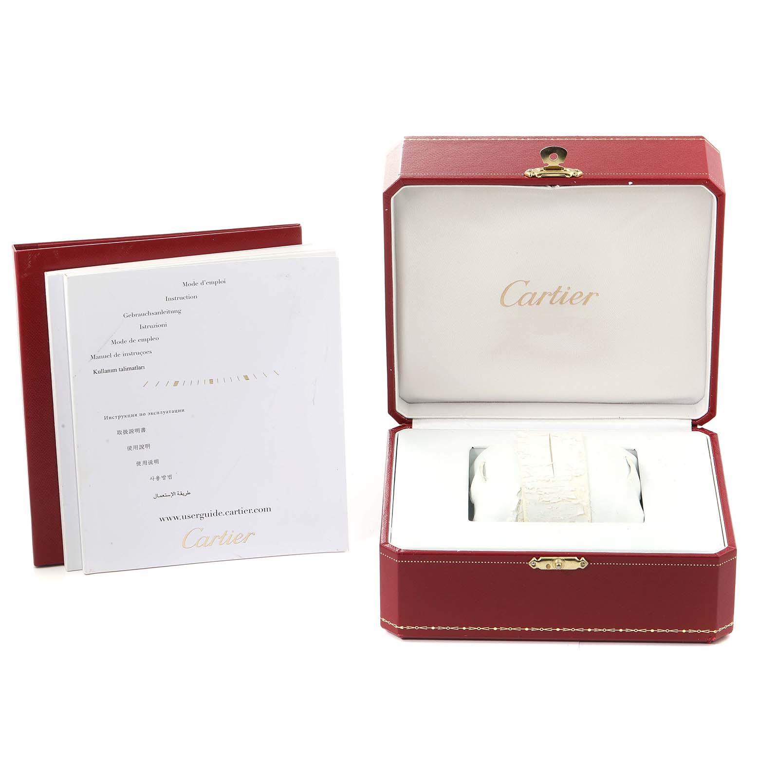 The image shows the Calibre de Cartier watch by Cartier in its open red case, accompanied by user manuals on the side.