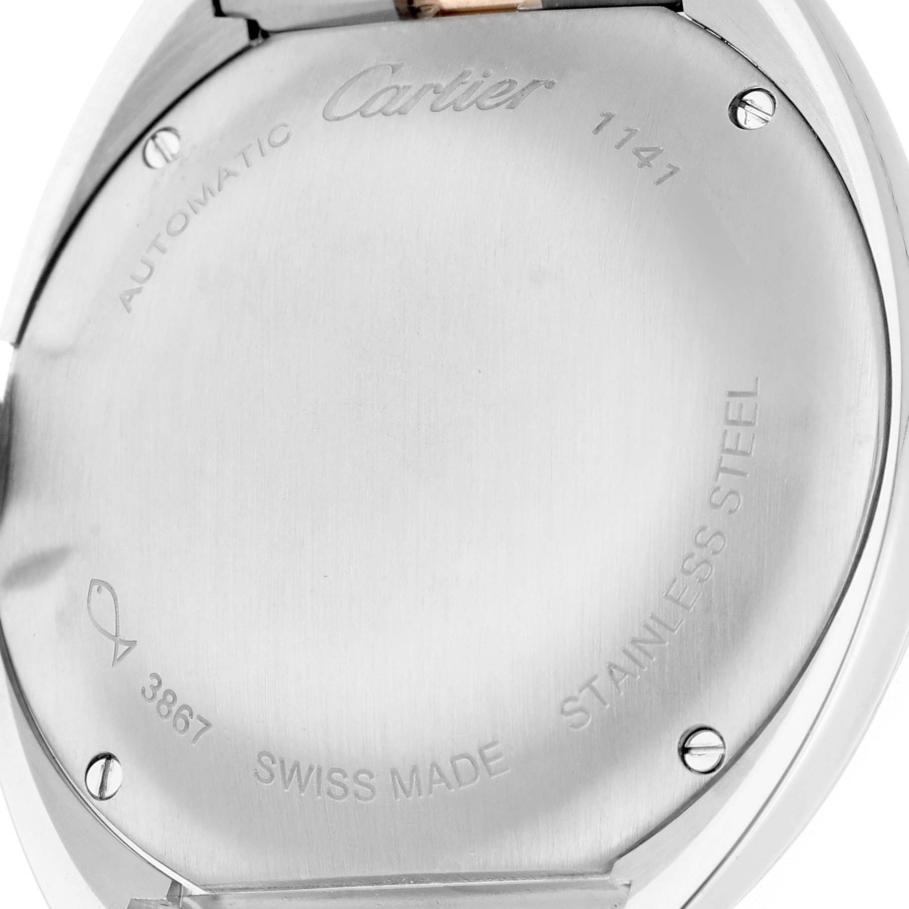 The image shows the back of a Cartier Clé model watch, highlighting its stainless steel case and engravings.