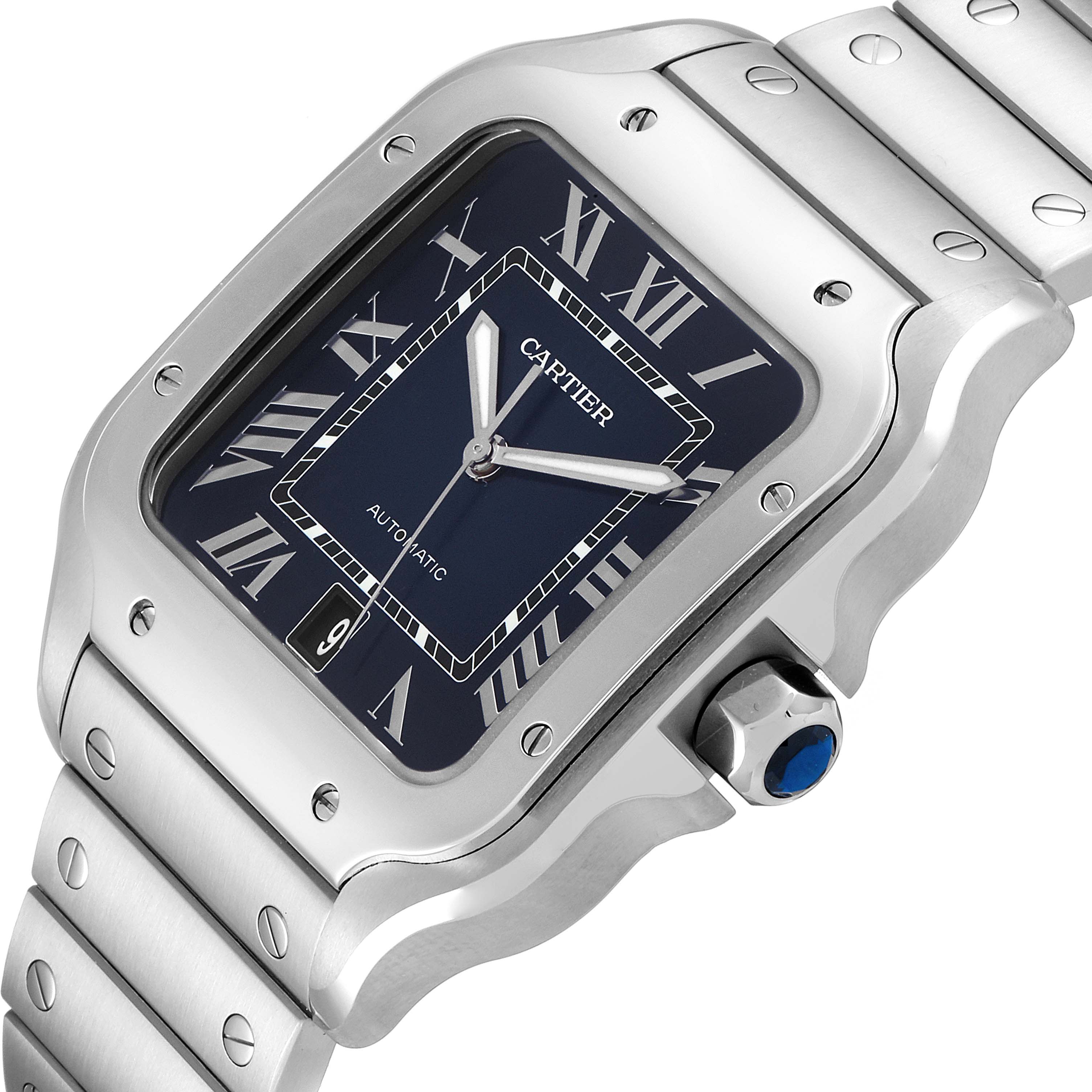 This image shows a close-up of a Cartier Santos WSSA0030 Men's Stainless Steel Blue Dial WSSA0030 Men's Stainless Steel Blue Dial watch face, bezel, crown, and part of the bracelet from an oblique angle.