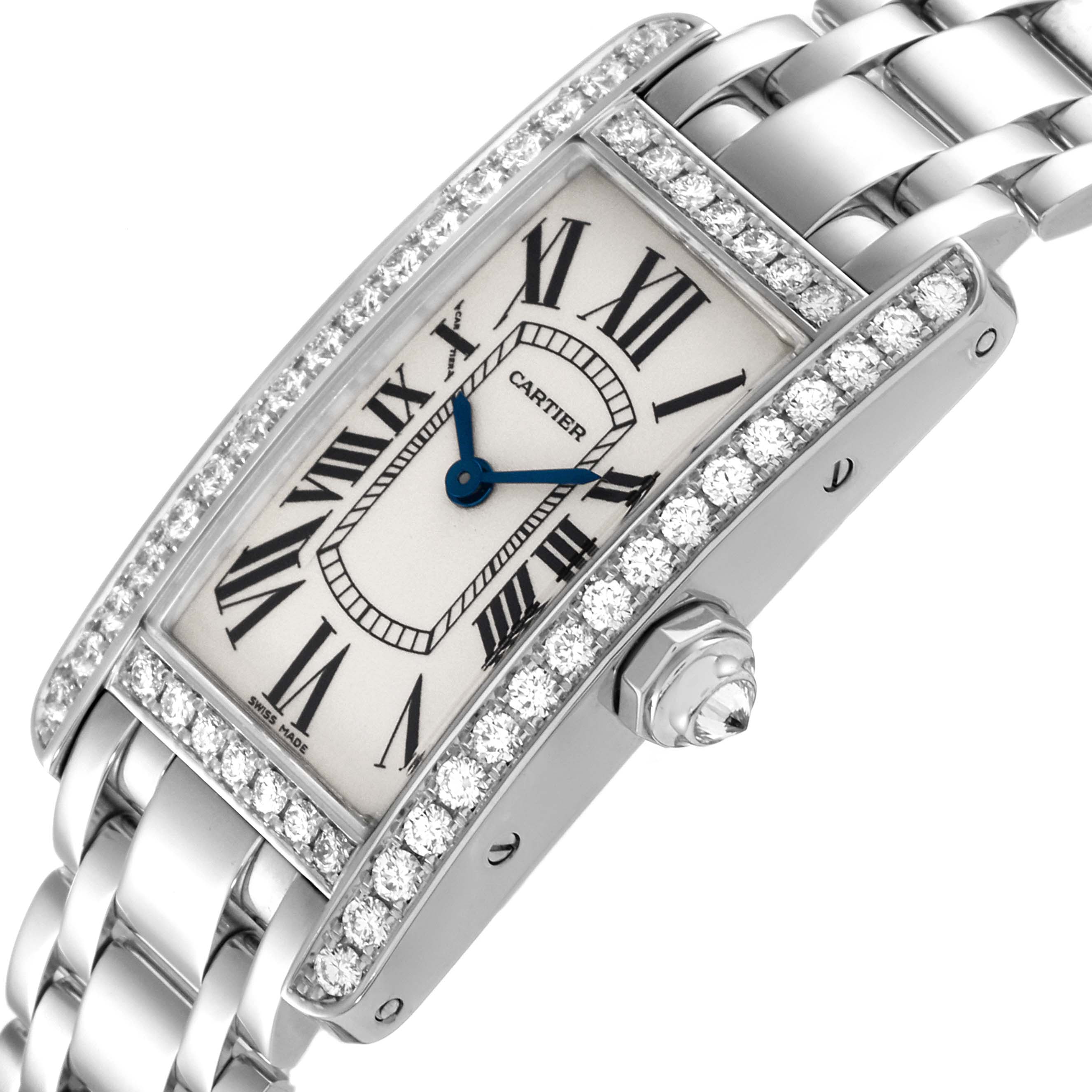 The image shows a close-up angled view of the Cartier Tank Americaine WB7073L1 Women's White Gold Silver Dial WB7073L1 Women's White Gold Silver Dial watch, highlighting its face, blue hands, and diamond-studded bezel.
