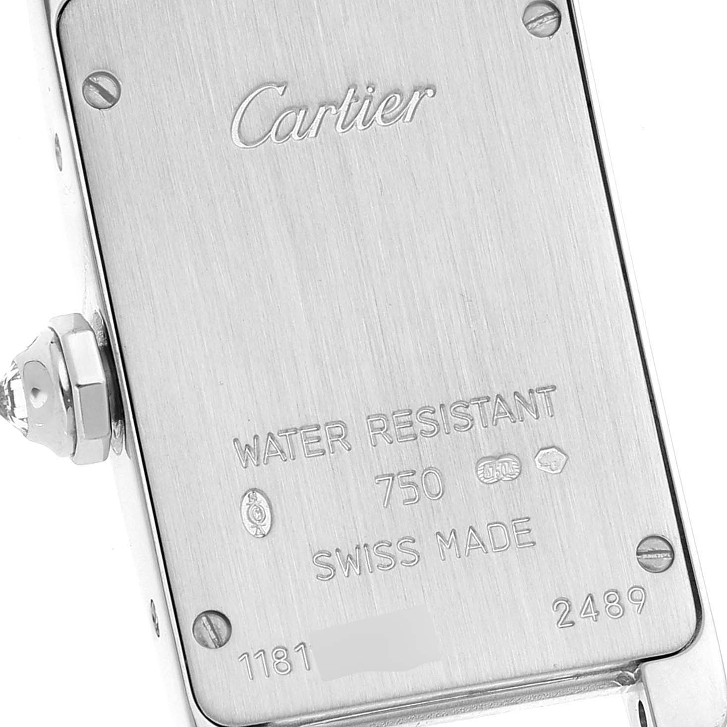 This image shows the case back of a Cartier Tank Americaine WB7073L1 Women's White Gold Silver Dial WB7073L1 Women's White Gold Silver Dial watch, displaying engravings and serial numbers.