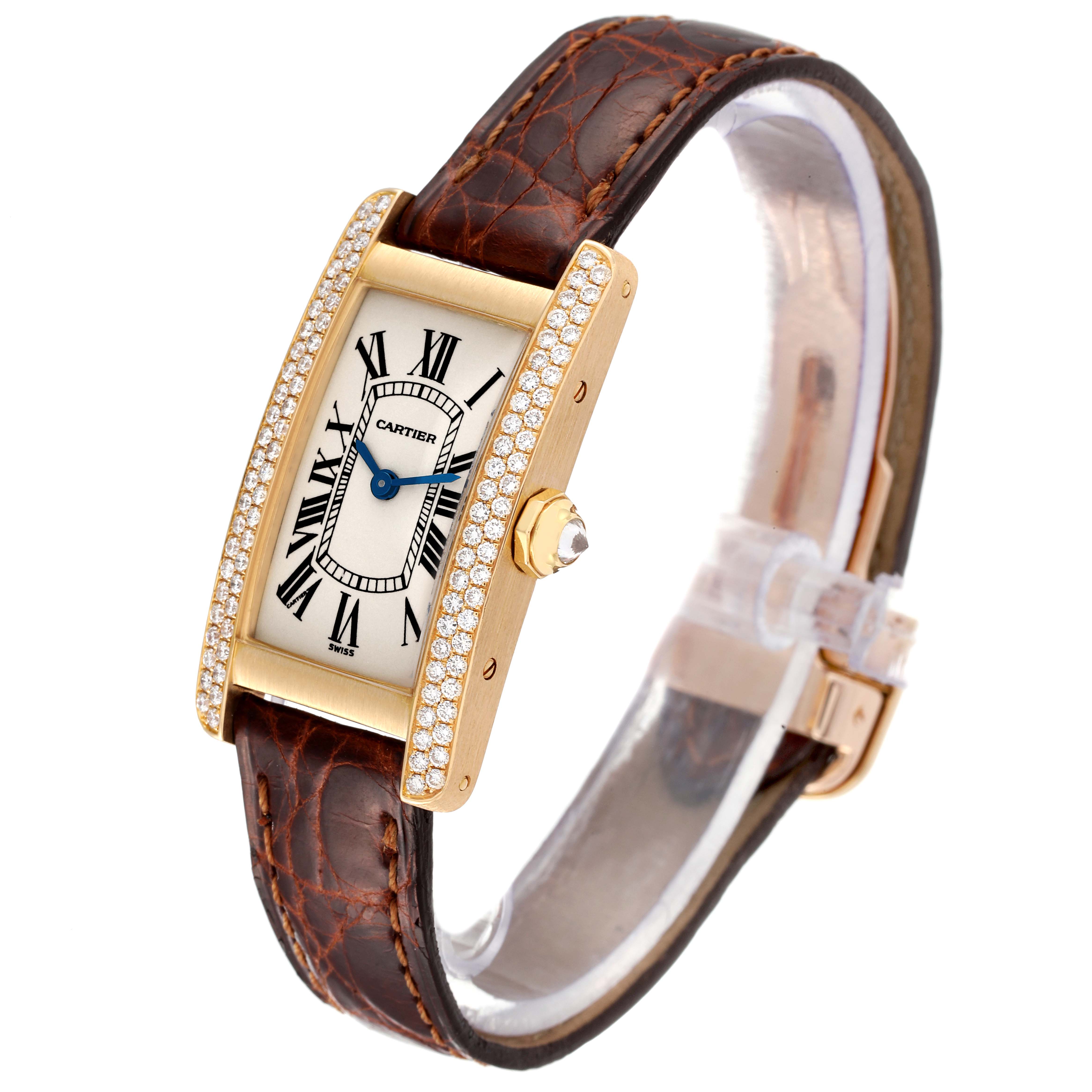 This Cartier Tank Americaine WB701251 Women
s Yellow Gold Silver Dial WB701251 Women
s Yellow Gold Silver Dial watch is shown at a slight angle, featuring its brown leather strap, diamond-encrusted bezel, and rectangular face.