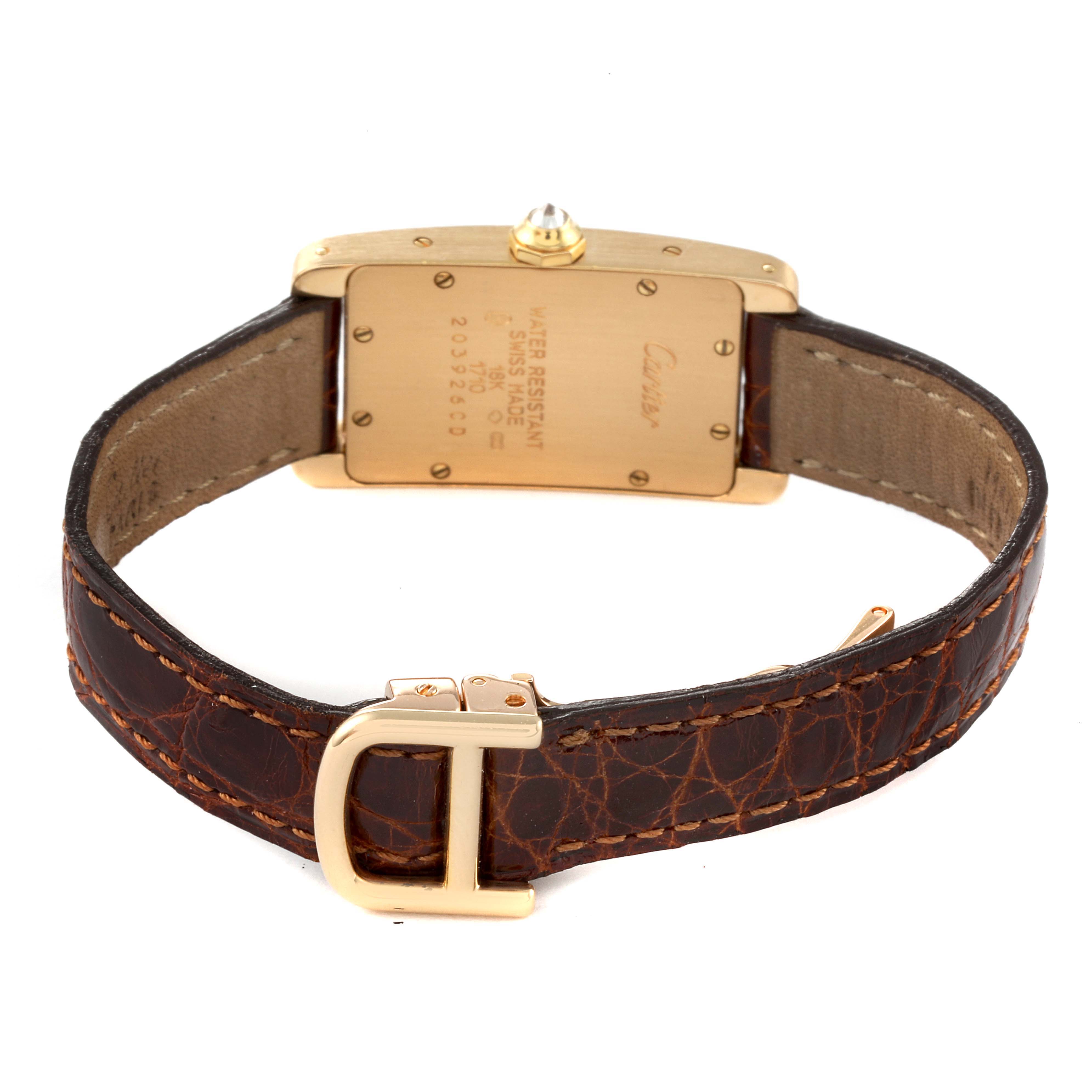 This image shows the back of a Cartier Tank Americaine WB701251 Women
s Yellow Gold Silver Dial WB701251 Women
s Yellow Gold Silver Dial watch, highlighting its clasp and leather strap.