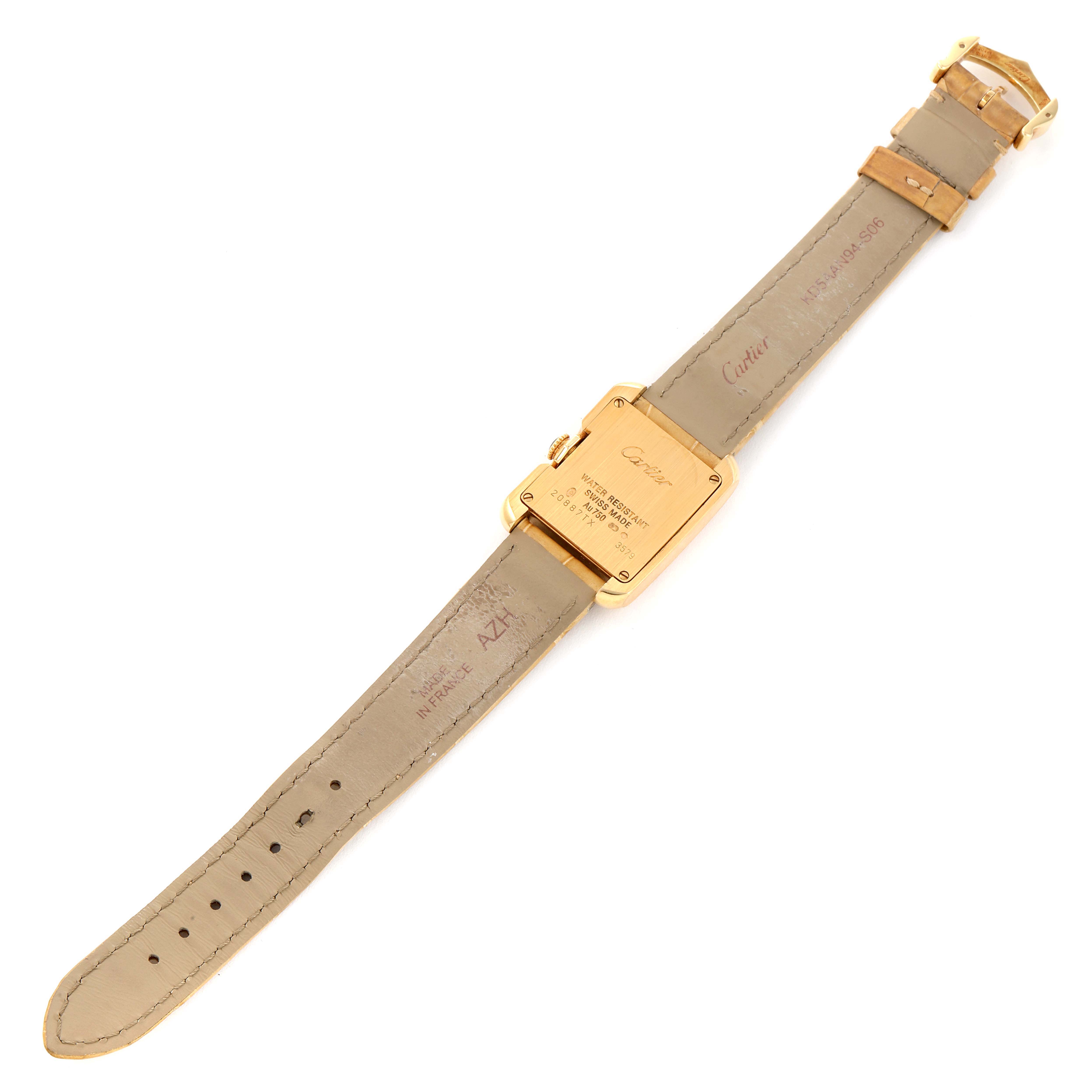 The image shows the back and strap of a Cartier Tank Anglaise W5310028 Women's Yellow Gold Silver Dial W5310028 Women's Yellow Gold Silver Dial watch, highlighting the engraved case back and leather strap.