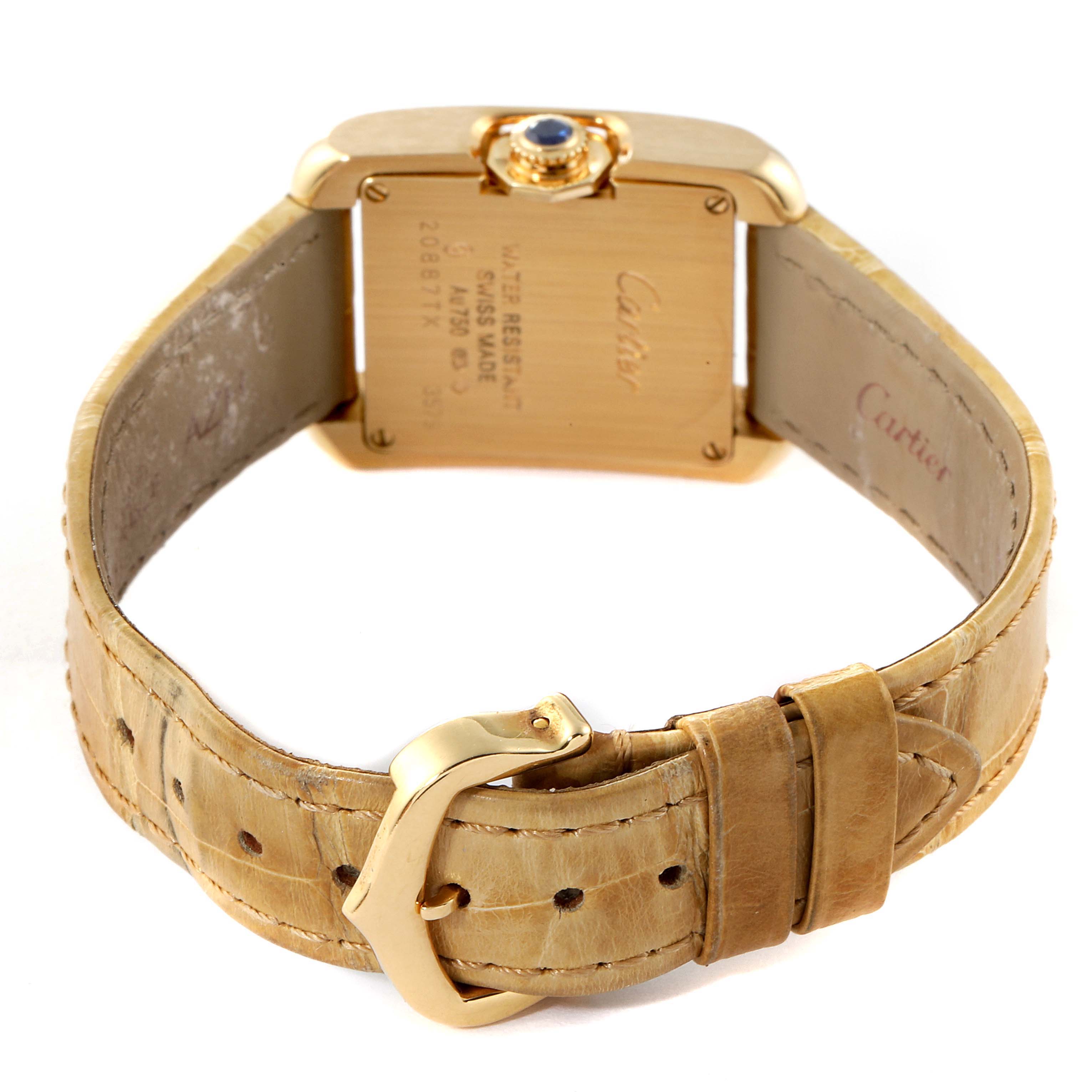 The image shows the back view of a Cartier Tank Anglaise W5310028 Women's Yellow Gold Silver Dial W5310028 Women's Yellow Gold Silver Dial watch, highlighting the golden clasp, strap, and case back with inscriptions.