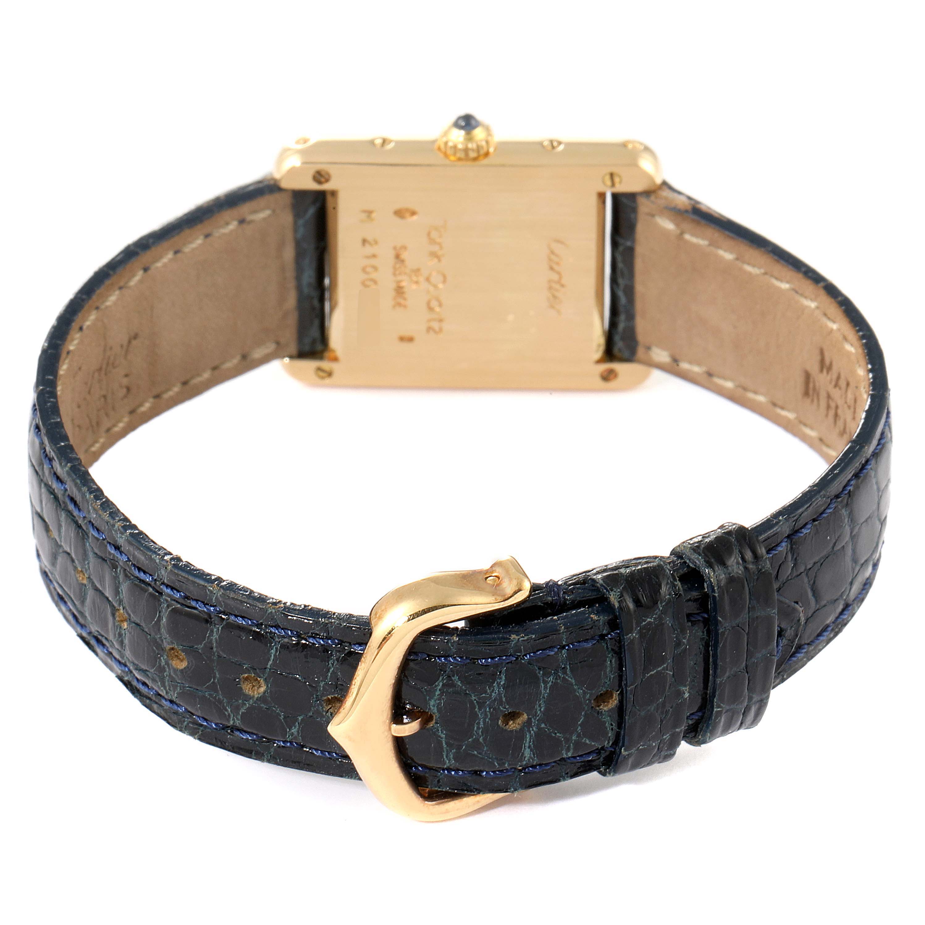 The image shows the rear view of the Tank Classic watch by Cartier, focusing on the back case and leather strap with a buckle.