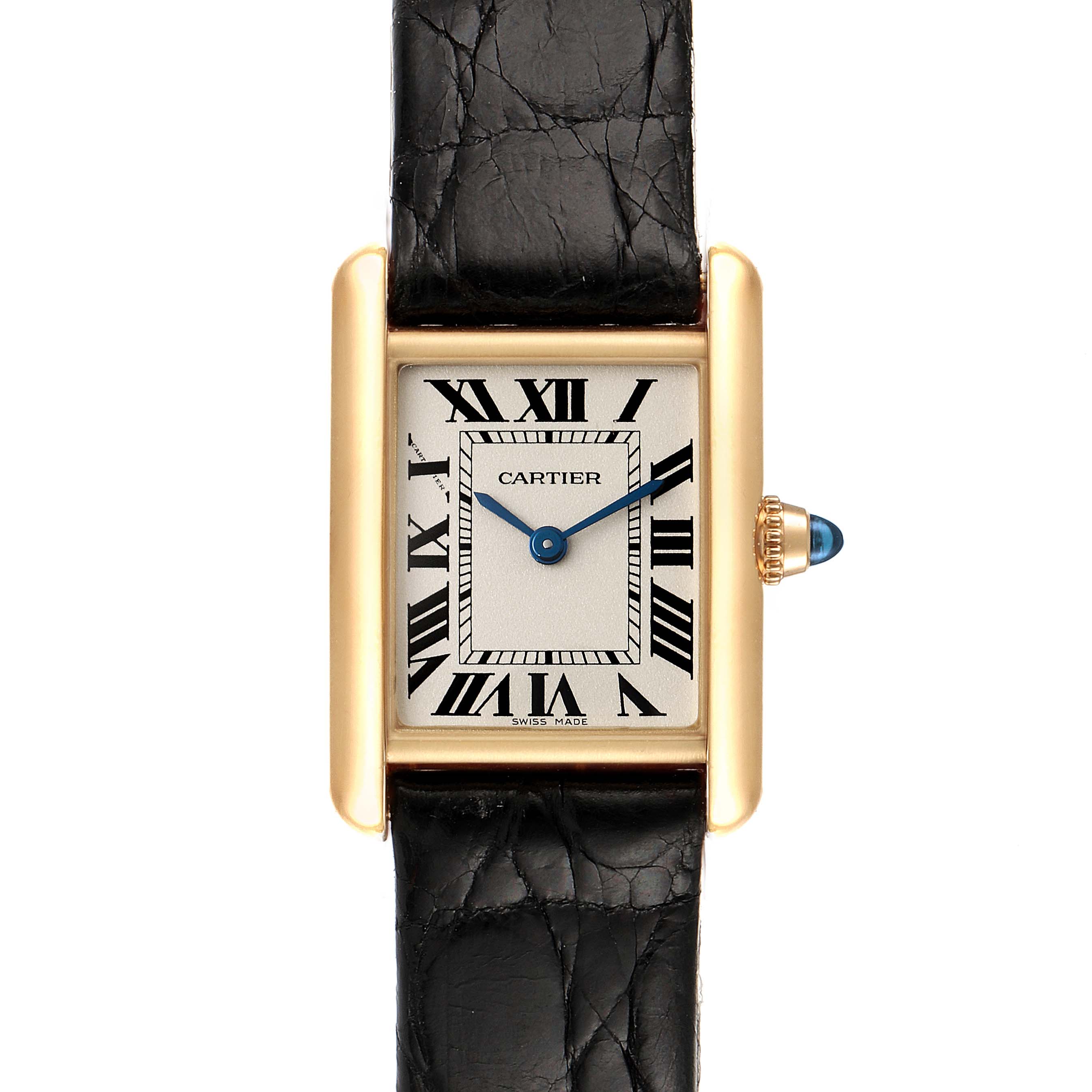 The image shows a front view of the Cartier Tank Louis W1529856 Women's Yellow Gold Silver Dial W1529856 Women's Yellow Gold Silver Dial watch, highlighting its gold case, black leather strap, Roman numerals, and blue hands.