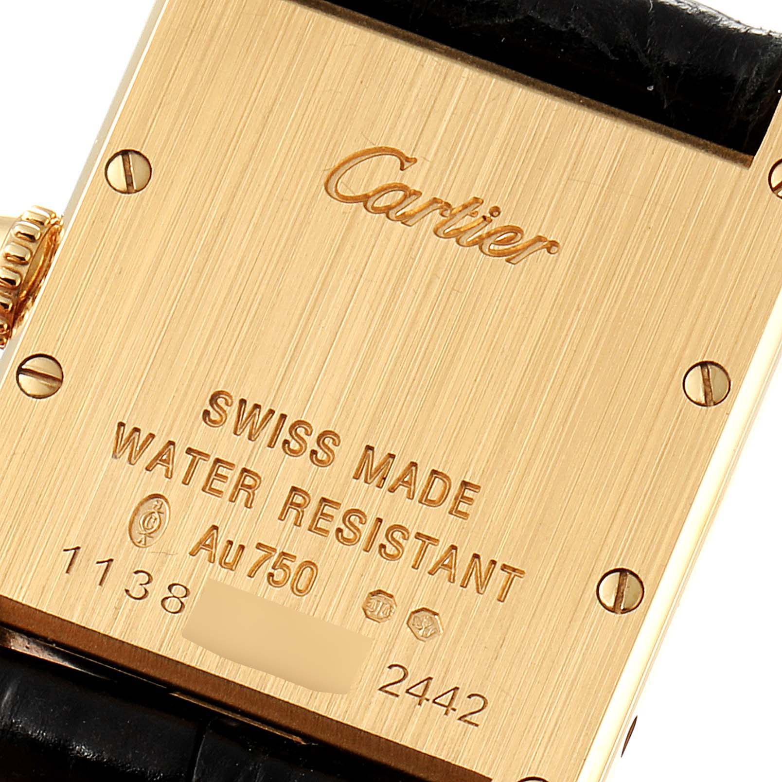 The image shows the back of the Tank Louis watch by Cartier, highlighting the engravings and screws.