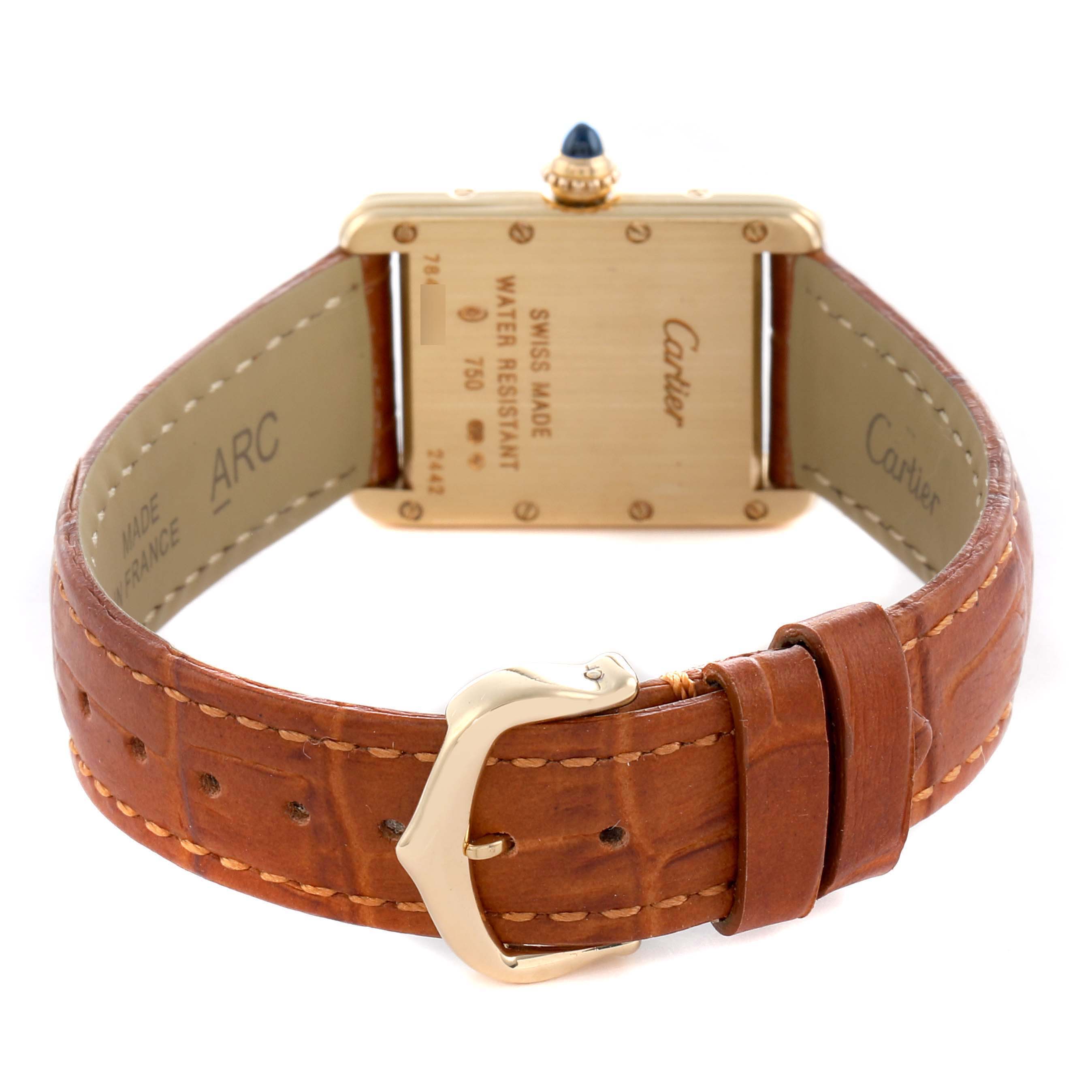 The image shows the back of a Cartier Tank Louis W1529856 Women's Yellow Gold Silver Dial watch, highlighting its gold case, leather strap, and buckle.