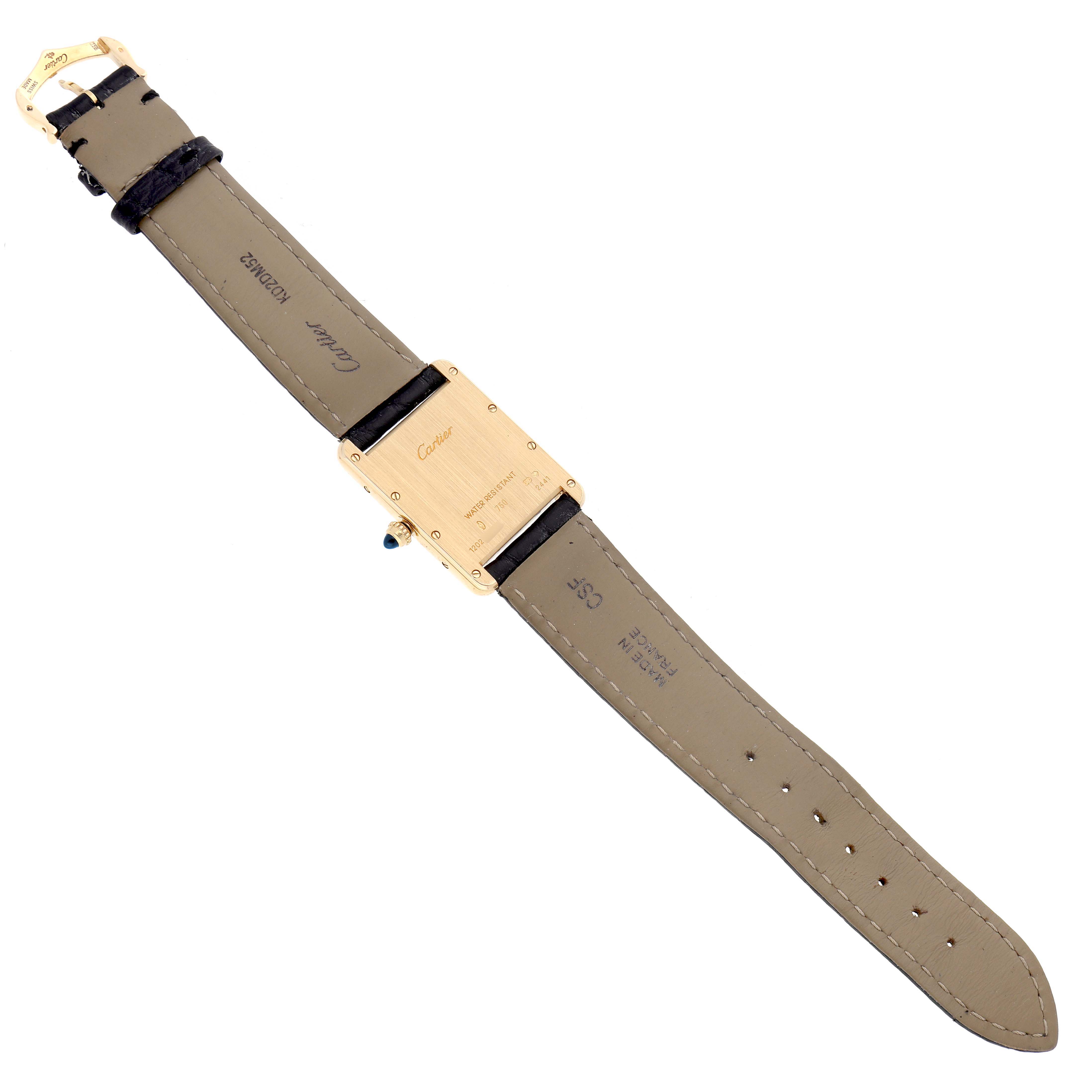 The Cartier Tank Louis W1529756 Men's Yellow Gold Silver Dial watch is shown from the back, highlighting the case back, straps, and buckle.