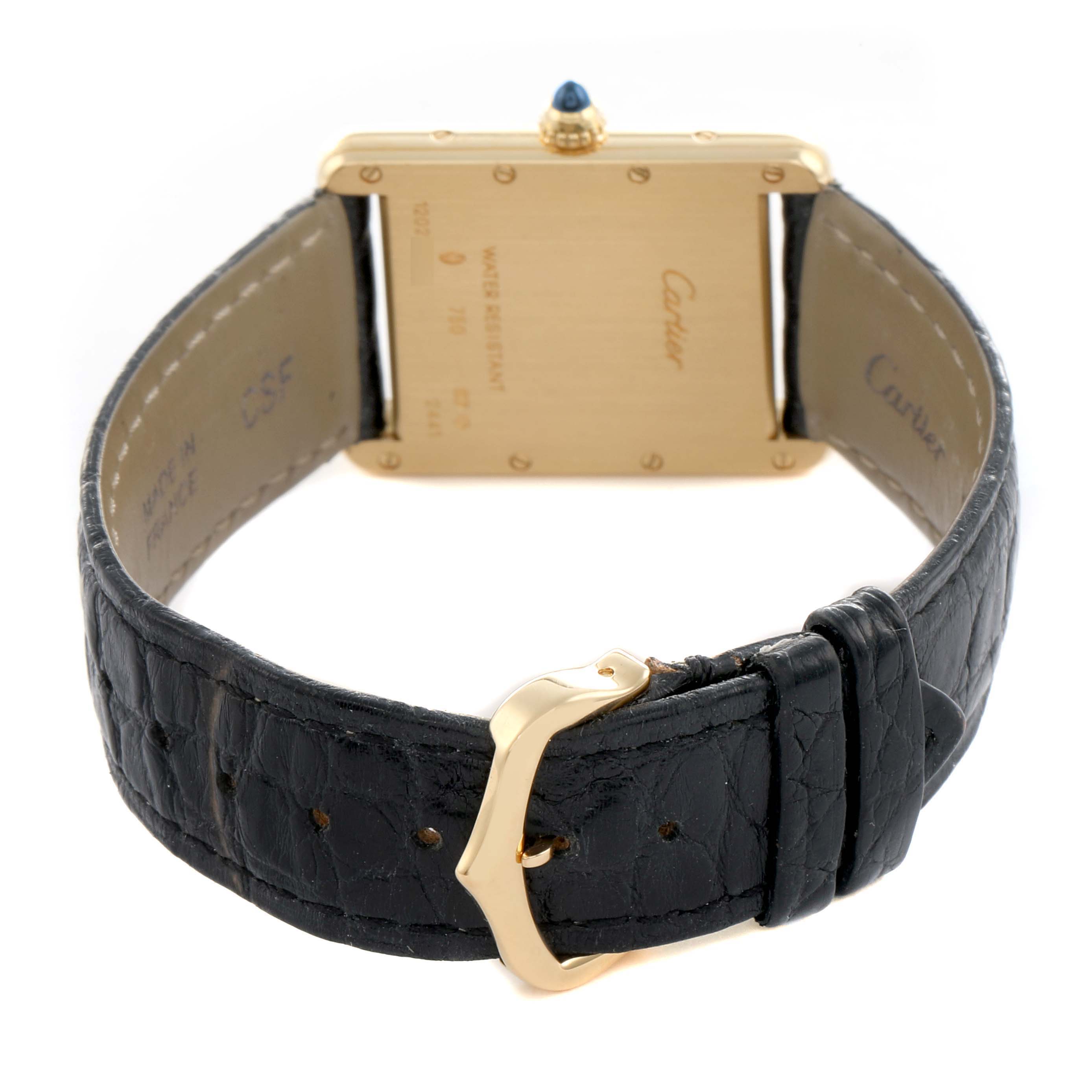 The image shows the back of a Cartier Tank Louis W1529756 Men's Yellow Gold Silver Dial watch, highlighting the case back, strap, and clasp.