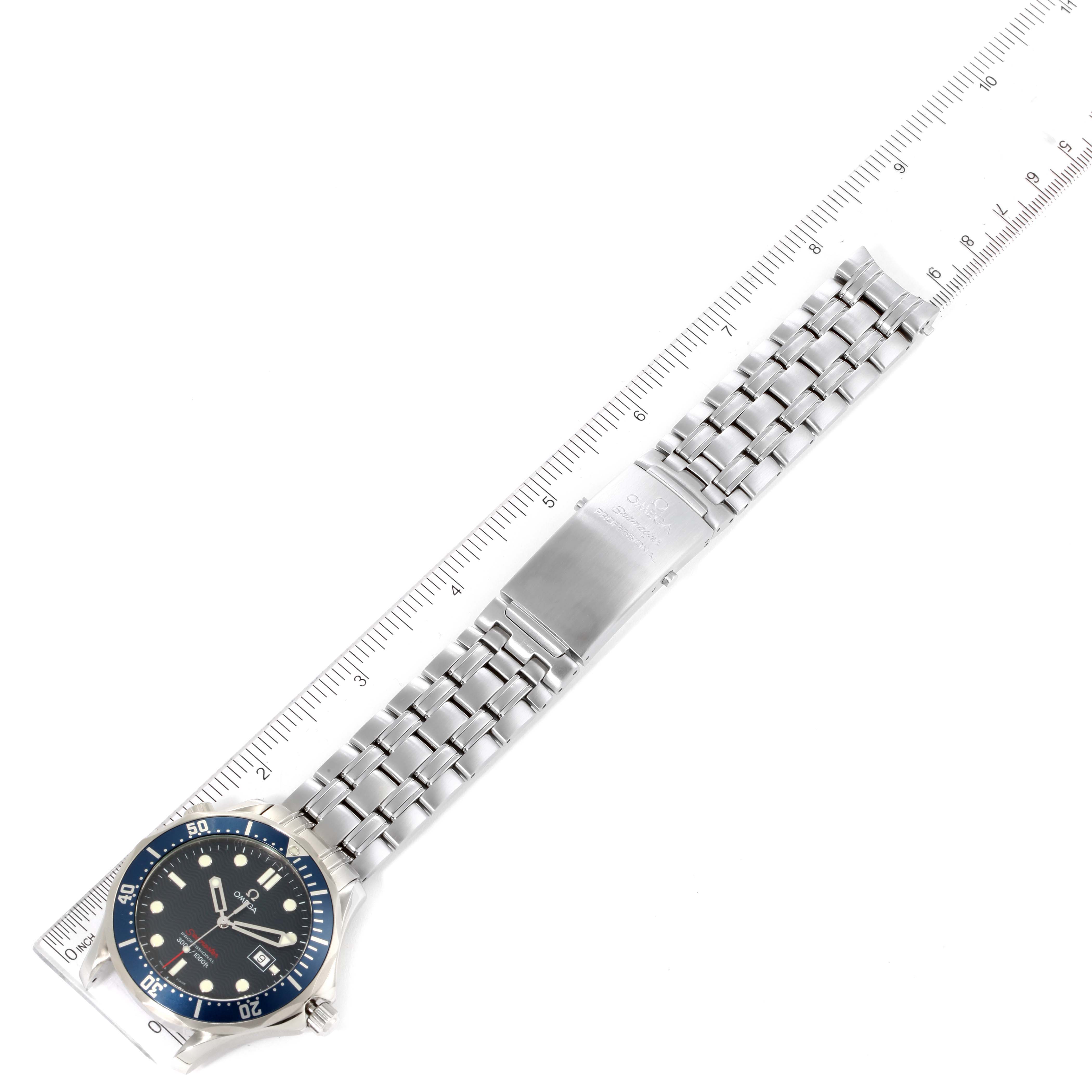 The image shows an Omega Seamaster 2221.80.00 Men's Stainless Steel Blue Dial 2221.80.00 Men's Stainless Steel Blue Dial watch laid flat, displaying its face, bezel, and metal bracelet against a ruler for scale.