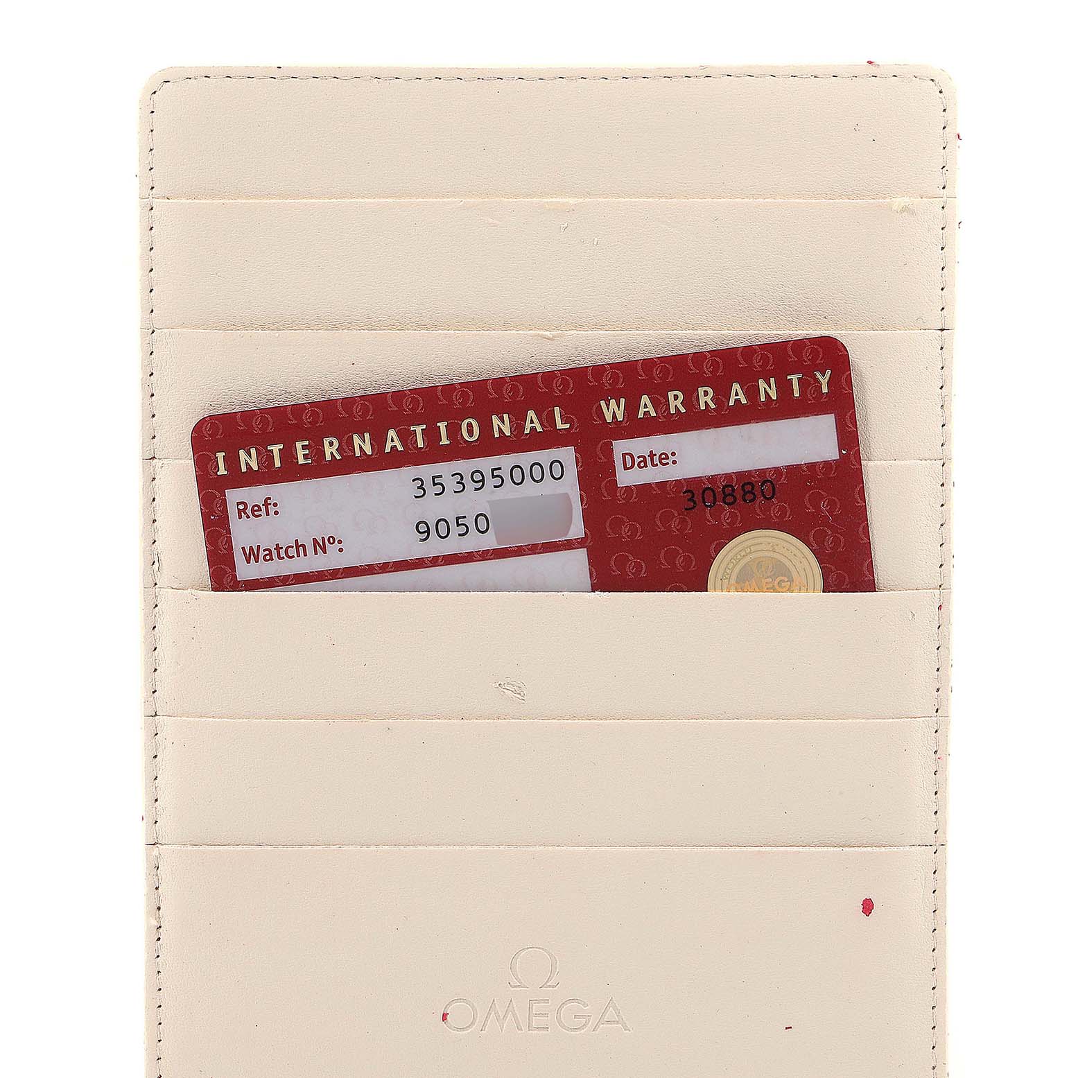 This image shows an Omega Speedmaster 3539.50.00 Men's Stainless Steel Black Dial 3539.50.00 Men's Stainless Steel Black Dial international warranty card partially inside a beige cardholder, viewed from the front.