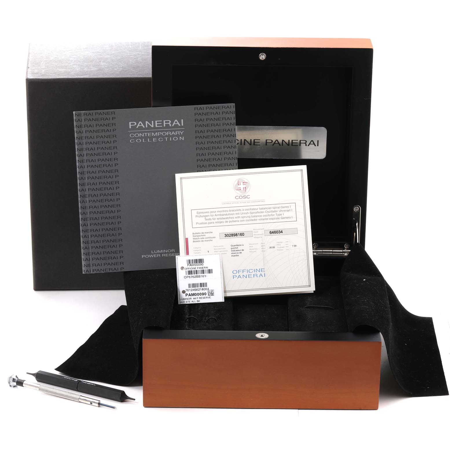 The image shows the packaging and accessories of a Panerai Luminor PAM00090 Men
s Stainless Steel Black Dial PAM00090 Men
s Stainless Steel Black Dial watch, including the box, manuals, and tools.