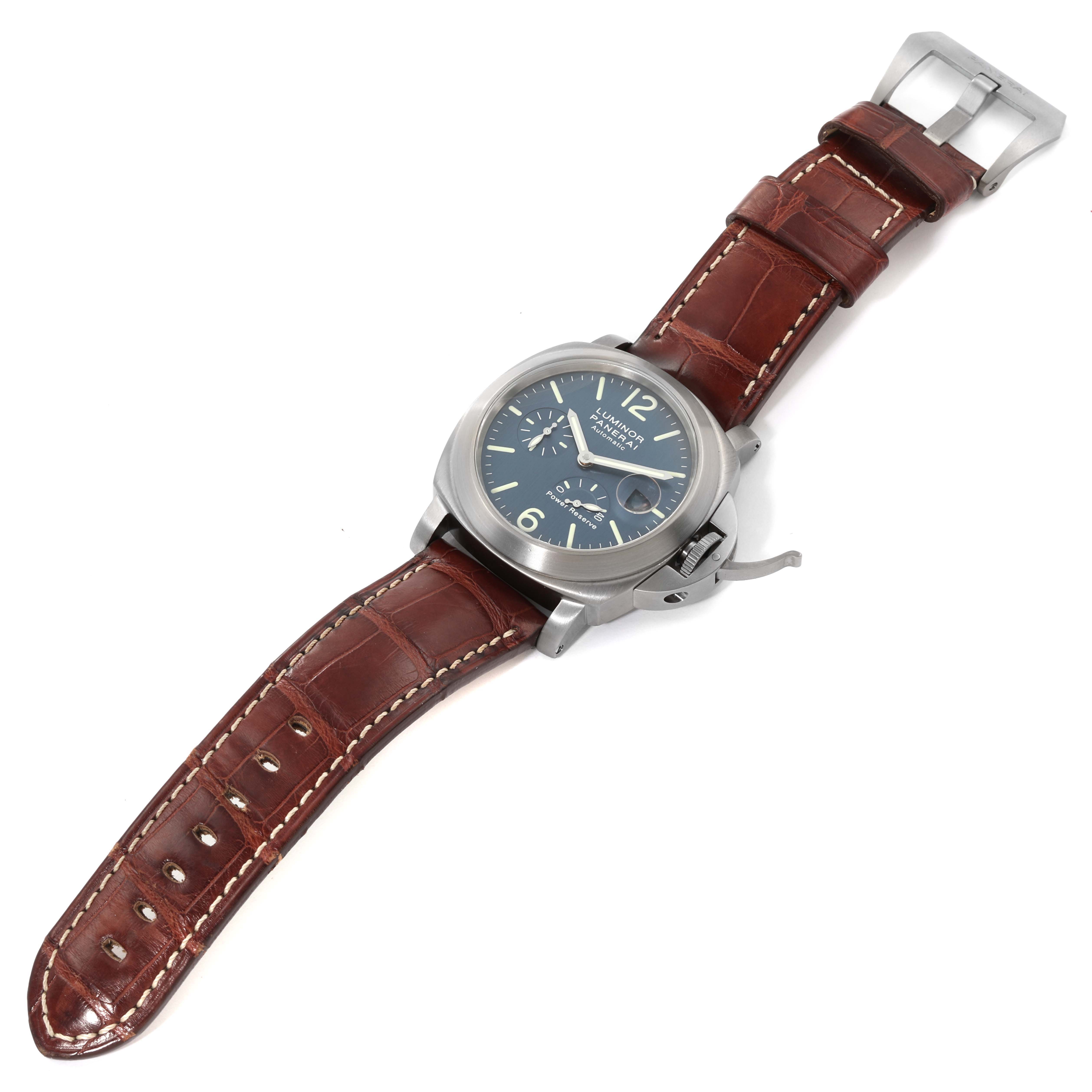 The Panerai Luminor PAM00093 Men's Titanium Blue Dial PAM00093 Men's Titanium Blue Dial watch is shown at a slight angle, highlighting its face, casing, and brown leather strap.