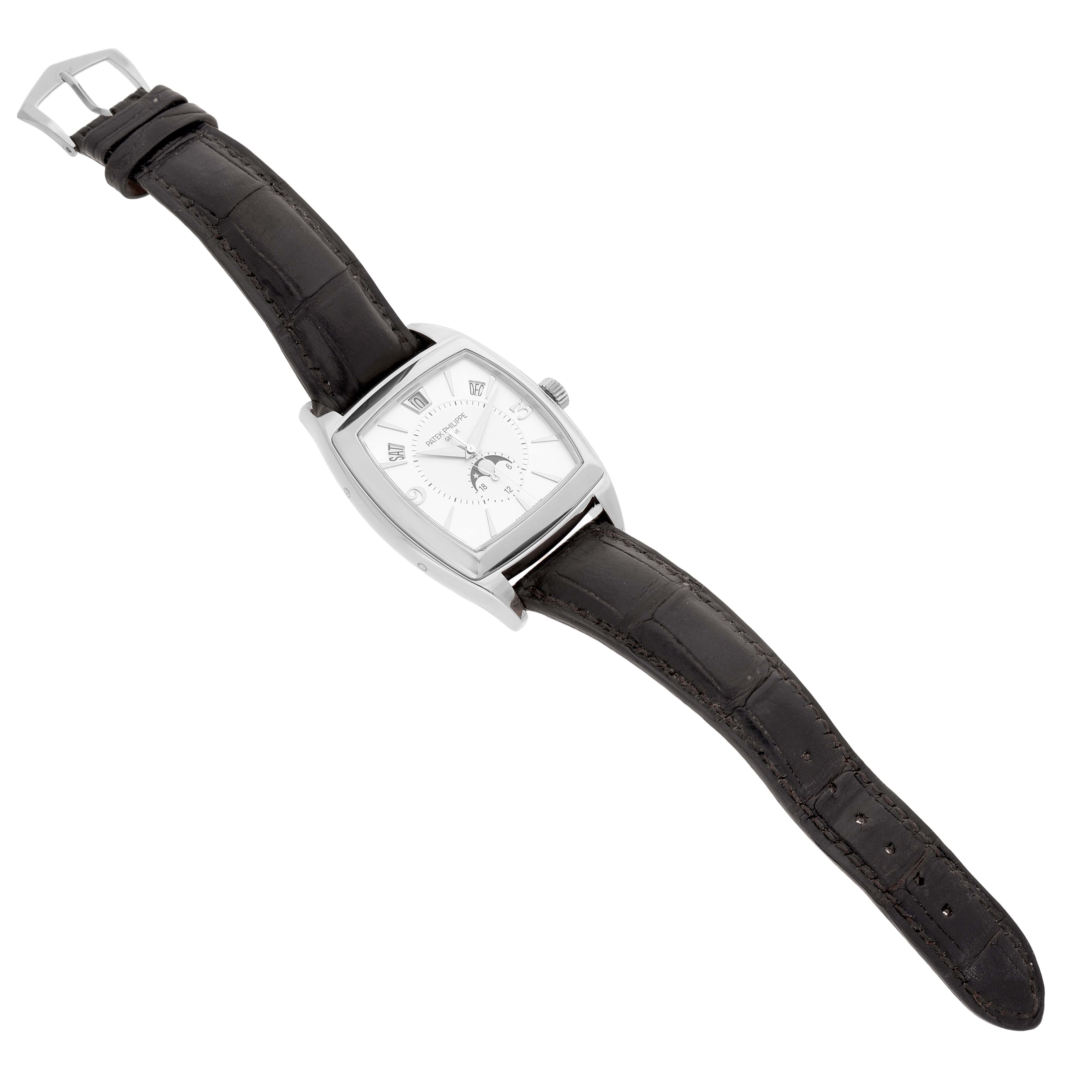 The Patek Philippe Gondolo Men's White Gold Silver Dial watch is shown at a diagonal angle, displaying the face, case, crown, and black leather strap.