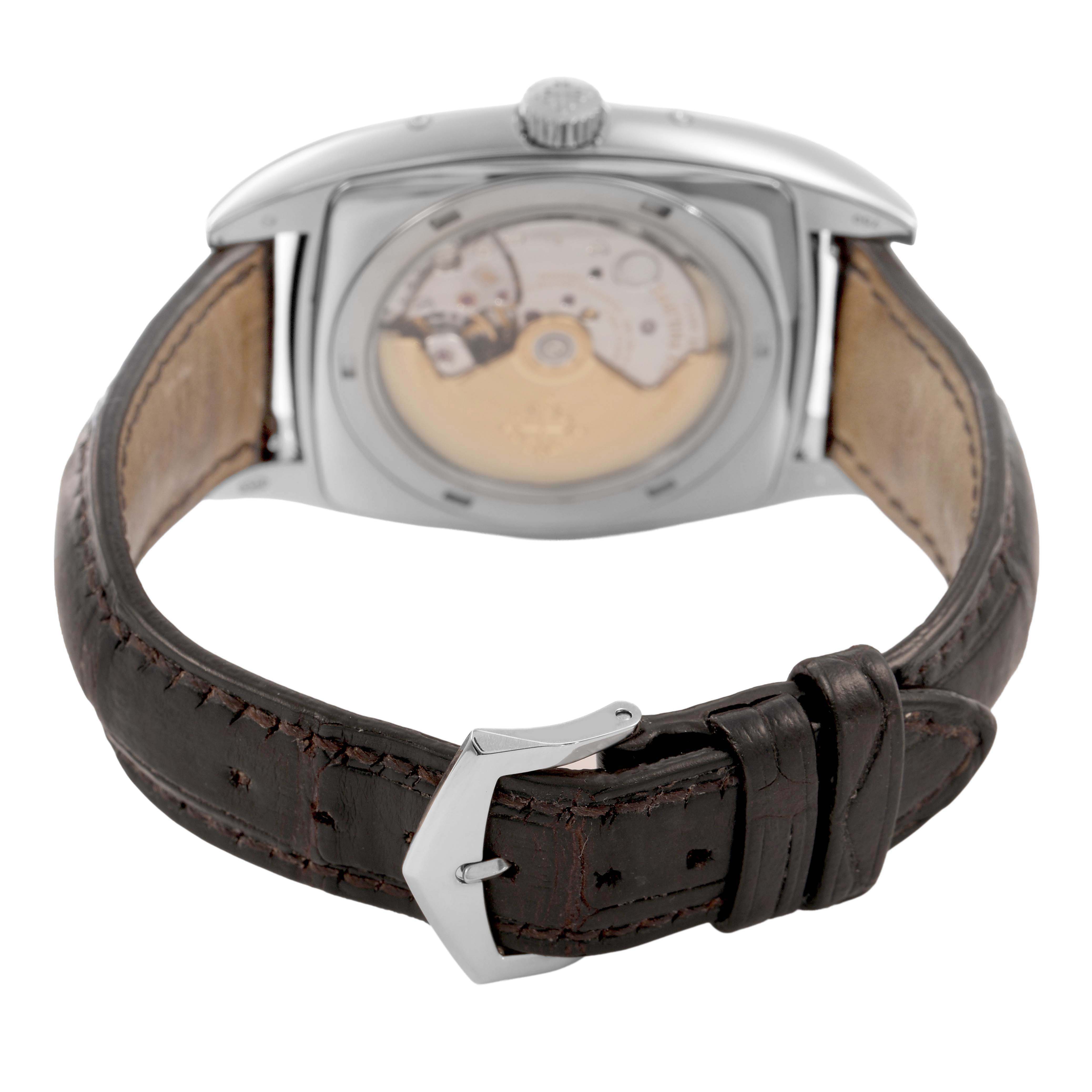 The Patek Philippe Gondolo Men's White Gold Silver Dial watch is shown from the rear, displaying its movement and leather strap with a buckle.