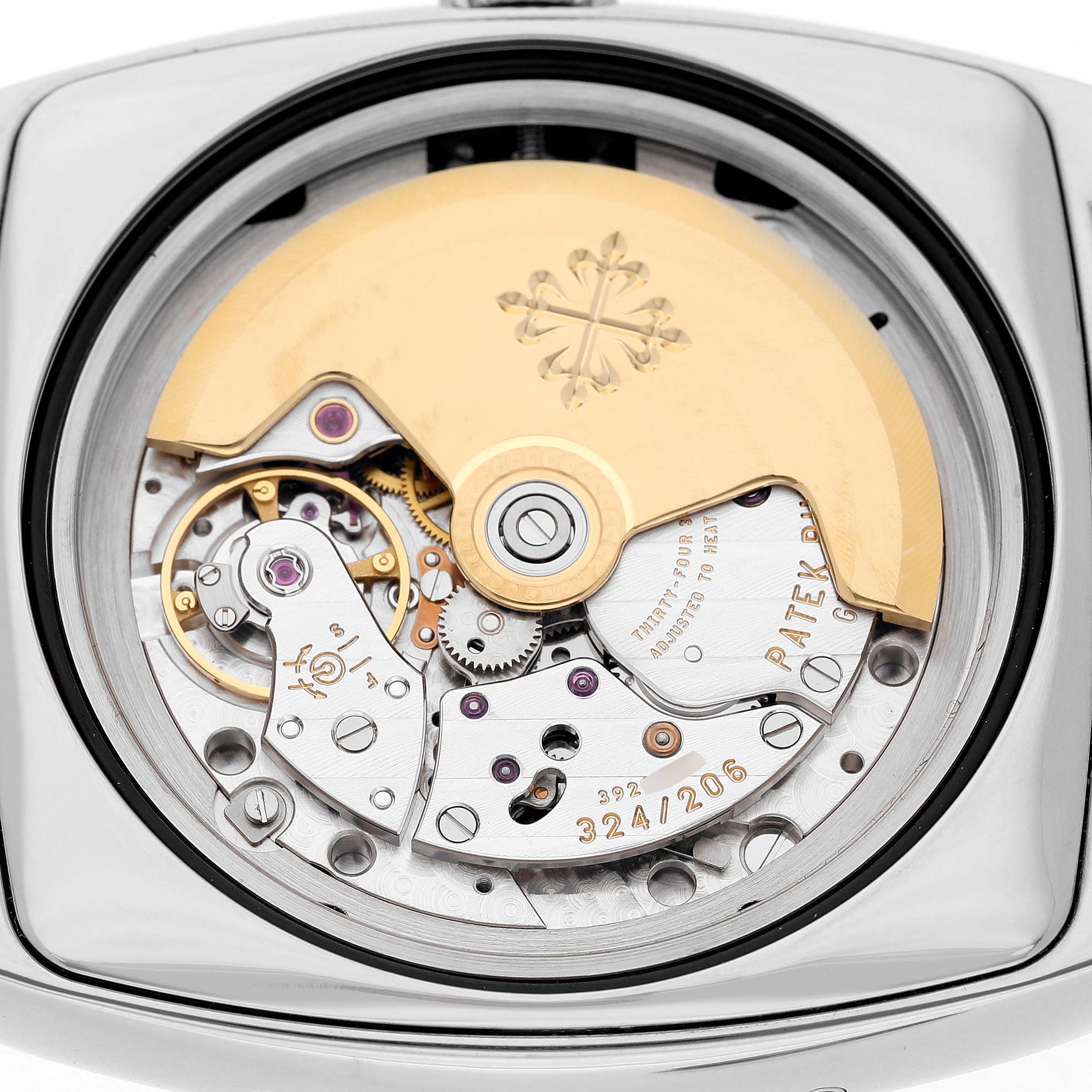 The image shows the case back and movement of the Patek Philippe Gondolo Men's White Gold Silver Dial watch, highlighting the gold rotor and mechanical components.