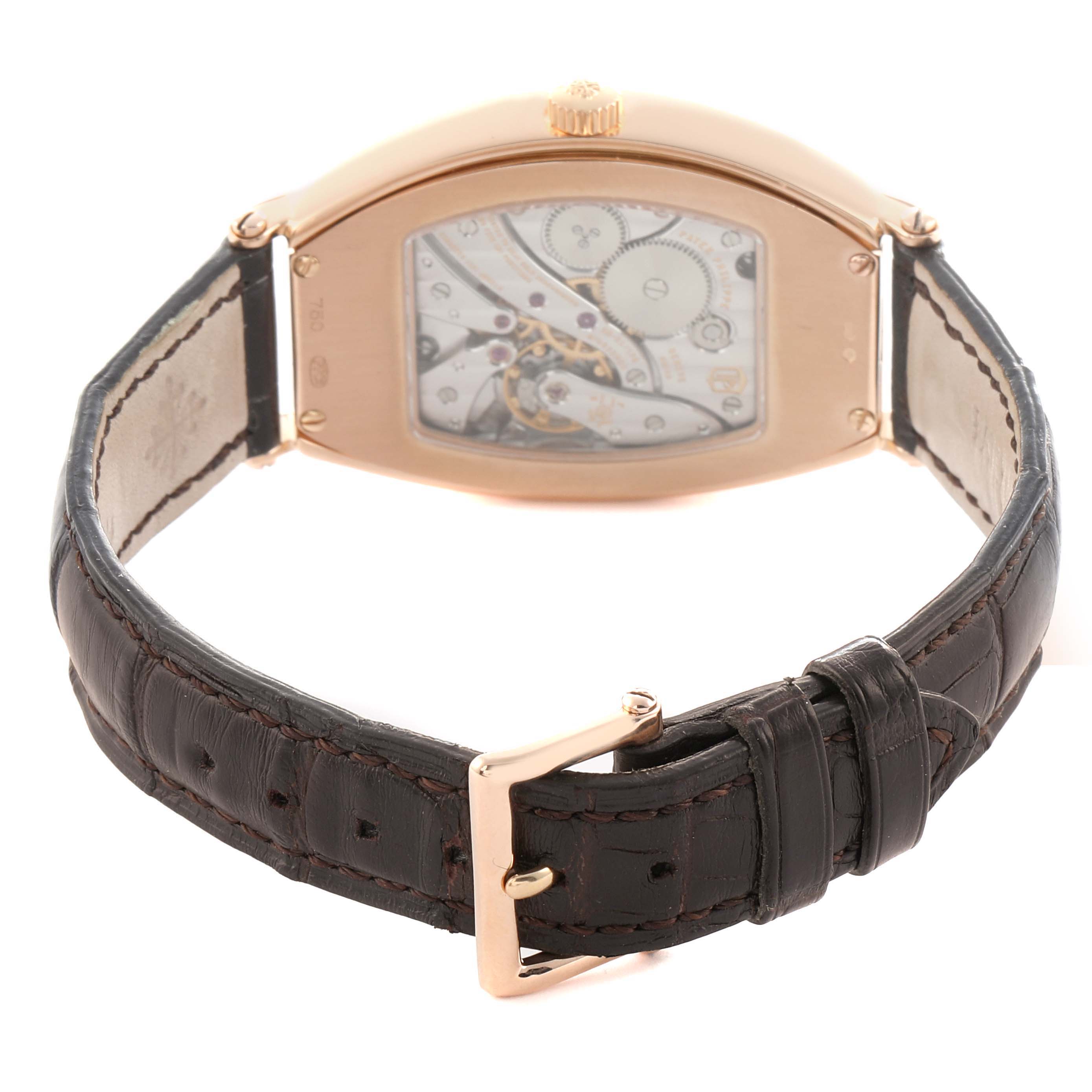 The Patek Philippe Gondolo 5098R Men's Rose Gold Silver Dial watch is shown from the back, highlighting the movement through the transparent caseback and the leather strap.