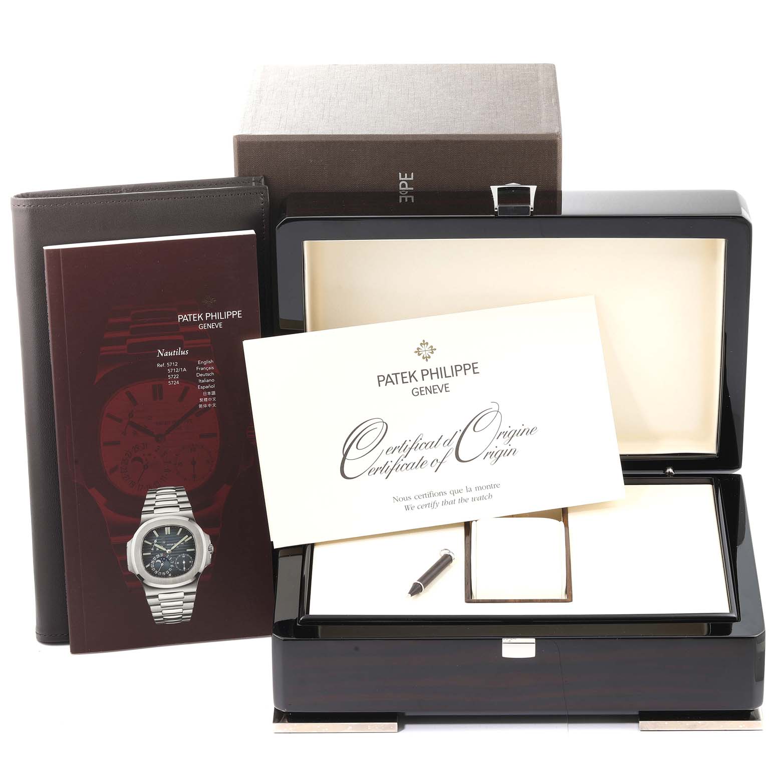 This image shows a Patek Philippe Nautilus 5712/1A-001 Men
s Stainless Steel Blue Dial 5712/1A-001 Men
s Stainless Steel Blue Dial watch box, accompanying documents, and a certificate of origin from an aerial perspective.