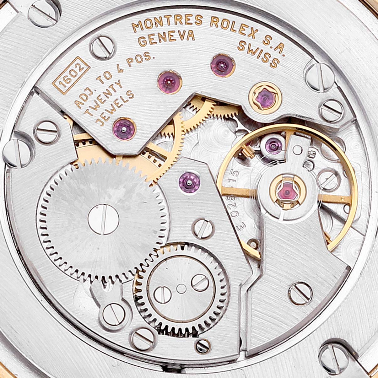 This image shows the intricate movement and internal components of a Rolex Cellini 5116 Men's Yellow Gold Beige Dial 5116 Men's Yellow Gold Beige Dial watch, taken from a close-up angle.