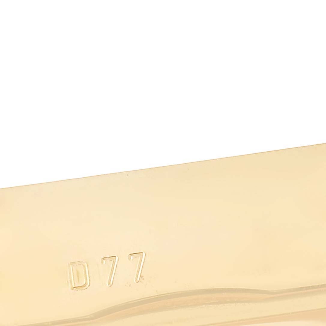 This close-up image shows a portion of the band clasp with "D77" engraved, of a Rolex Cellini 5440/8 Men's Yellow Gold Champagne Dial 5440/8 Men's Yellow Gold Champagne Dial watch.