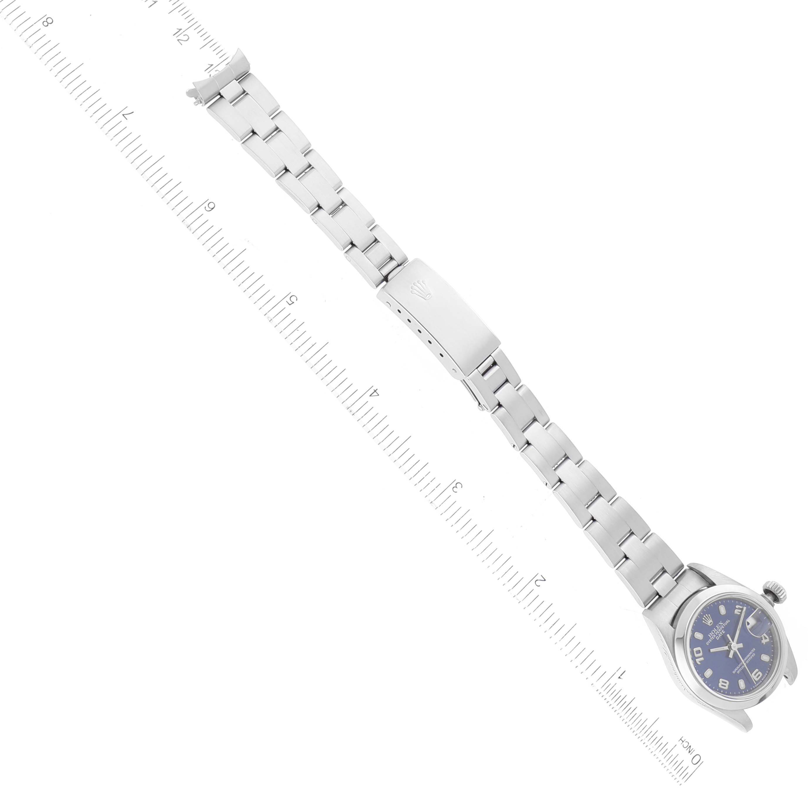 The image shows a Rolex Date 69160 Women's Stainless Steel Blue Dial 69160 Women's Stainless Steel Blue Dial model watch laid flat, aligned along a measured ruler, displaying the watch face, band, and clasp.