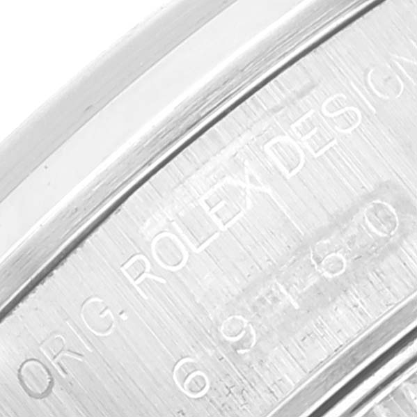 The image shows an angled close-up of the side of a Rolex Date 69160 Women's Stainless Steel Blue Dial 69160 Women's Stainless Steel Blue Dial watch case, highlighting the engraved text.