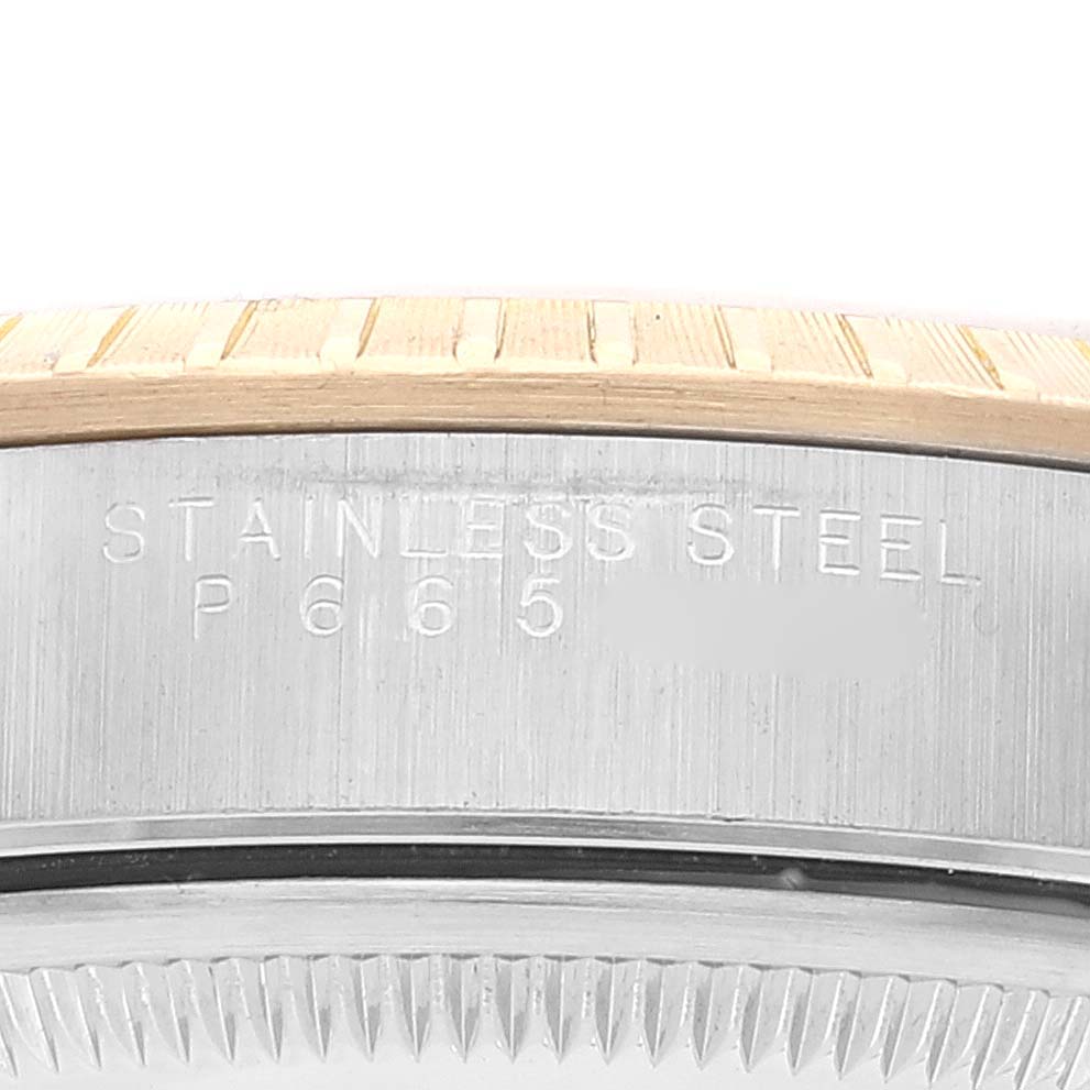The image shows a close-up of the case side and bezel of a Rolex Date 15223 Men's Steel and Gold (two tone) Champagne Dial 15223 Men's Steel and Gold (two tone) Champagne Dial model, displaying "STAINLESS STEEL".