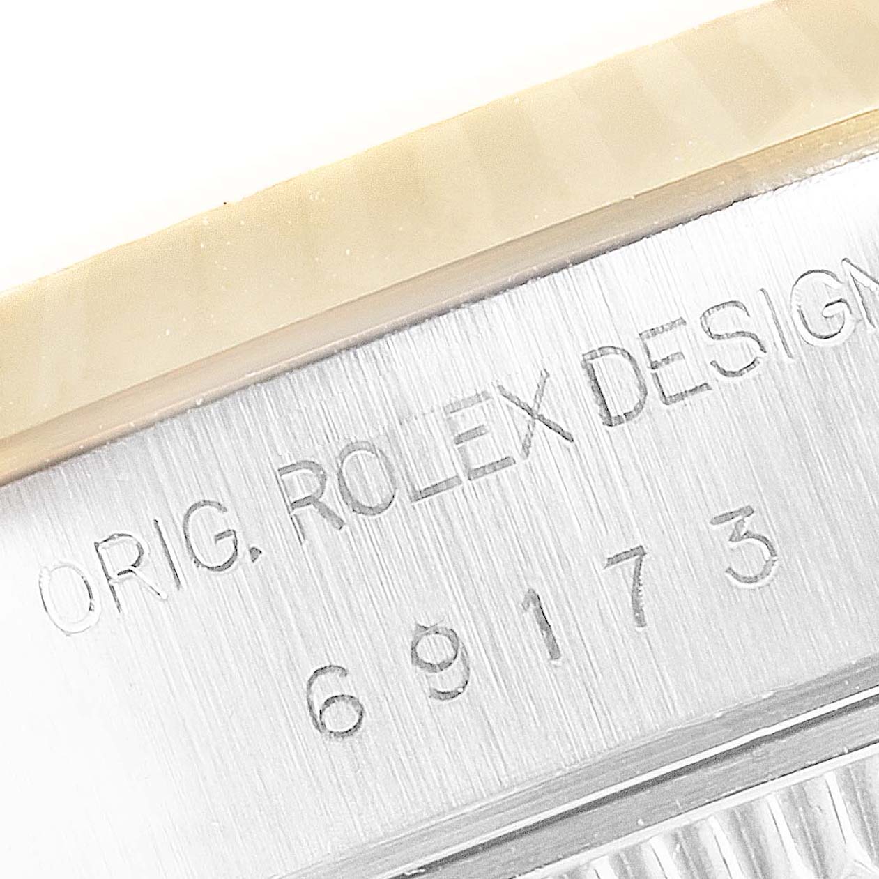 Close-up of the side of the bezel and serial number engraving on a Rolex Datejust 69173 Women's Steel and Gold (two tone) Blue Dial 69173 Women's Steel and Gold (two tone) Blue Dial watch.
