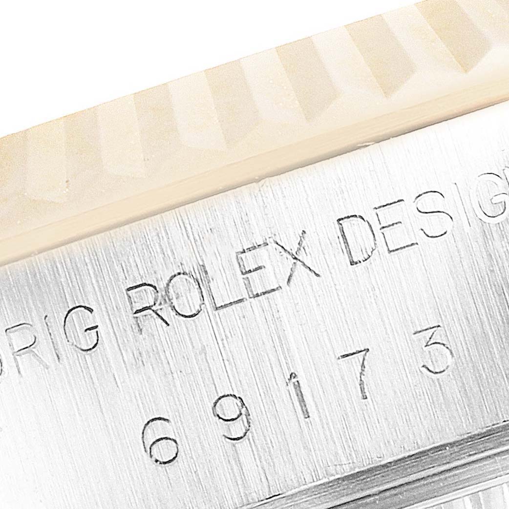 The image shows a close-up angle of the Rolex Datejust 69173 Women's Steel and Gold (two tone) Champagne Dial 69173 Women's Steel and Gold (two tone) Champagne Dial case, highlighting the model number and part of the fluted bezel.