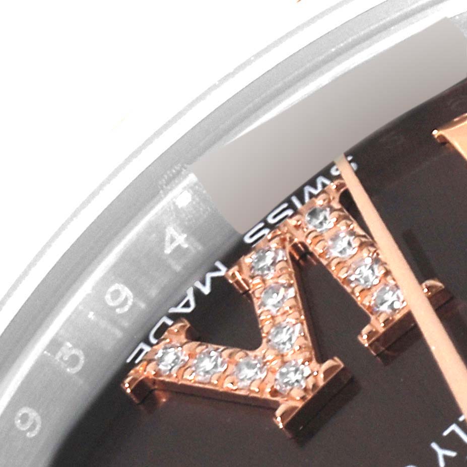 Close-up of the Rolex Mid-Size 178341 Women's Stainless Steel Brown Dial 178341 Women's Stainless Steel Brown Dial watch displaying part of the bezel, crystal hour marker, and "Swiss Made" text.