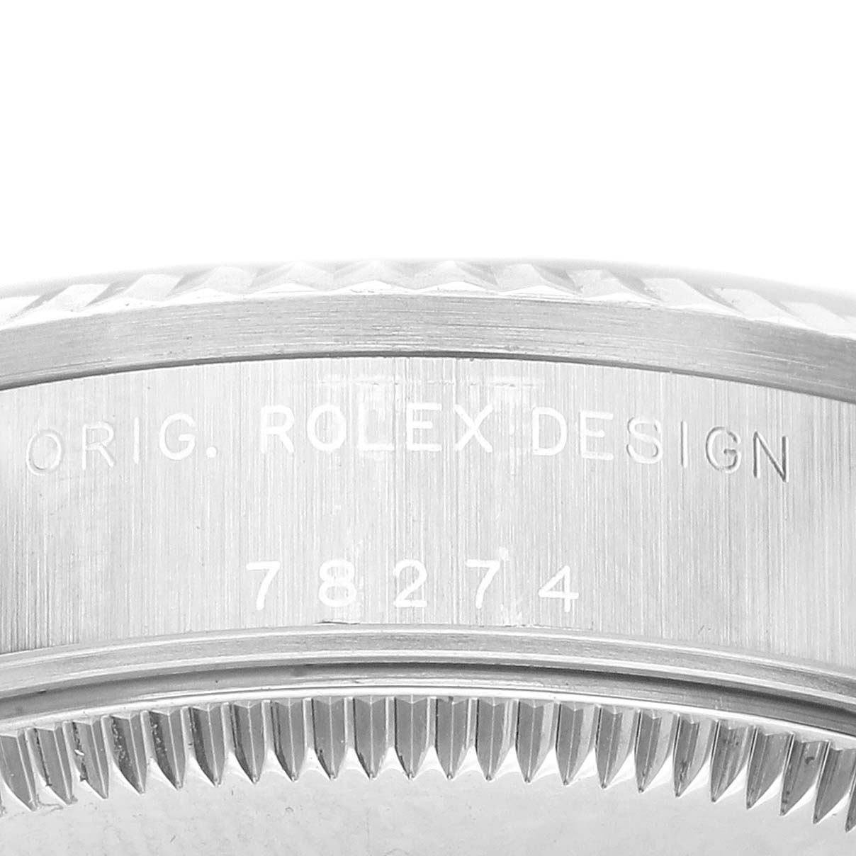 The image shows a close-up of the side engraving and fluted bezel of a Rolex Datejust 78274 Women's Stainless Steel Black Dial watch.