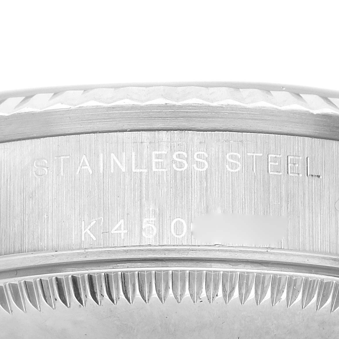 The image shows a close-up of the case back edge of the Rolex Datejust 78274 Women's Stainless Steel Black Dial, highlighting the "STAINLESS STEEL" engraving.