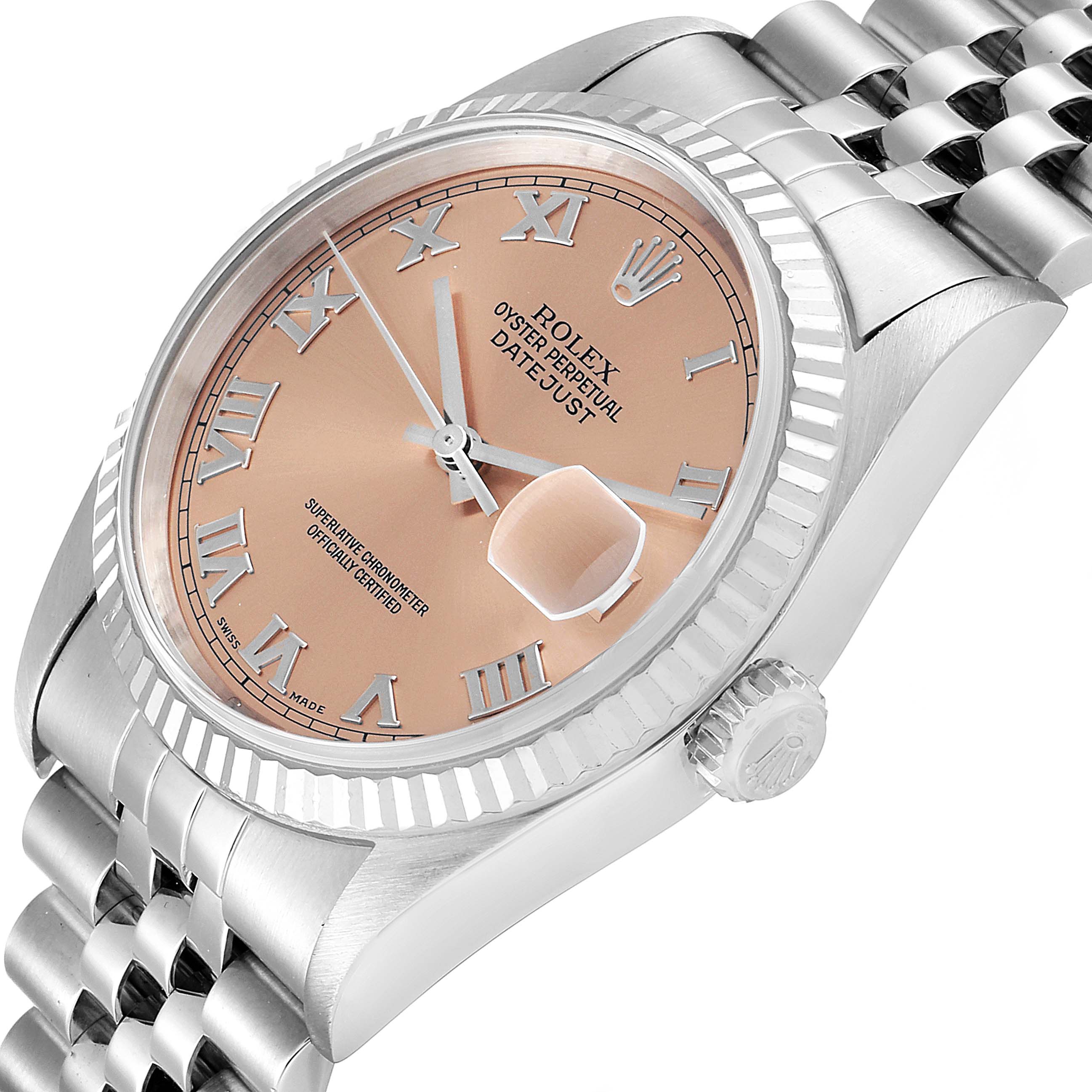 The Rolex Datejust 16234 Men's Stainless Steel Pink Dial 16234 Men's Stainless Steel Pink Dial watch is shown at an angled close-up, highlighting its dial, fluted bezel, and crown.