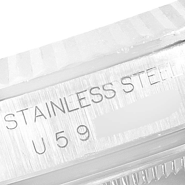 This image shows a close-up of the side of a Rolex Datejust 16234 Men's Stainless Steel Pink Dial 16234 Men's Stainless Steel Pink Dial watch, highlighting the "STAINLESS STEEL" engraving and part of the serial number.