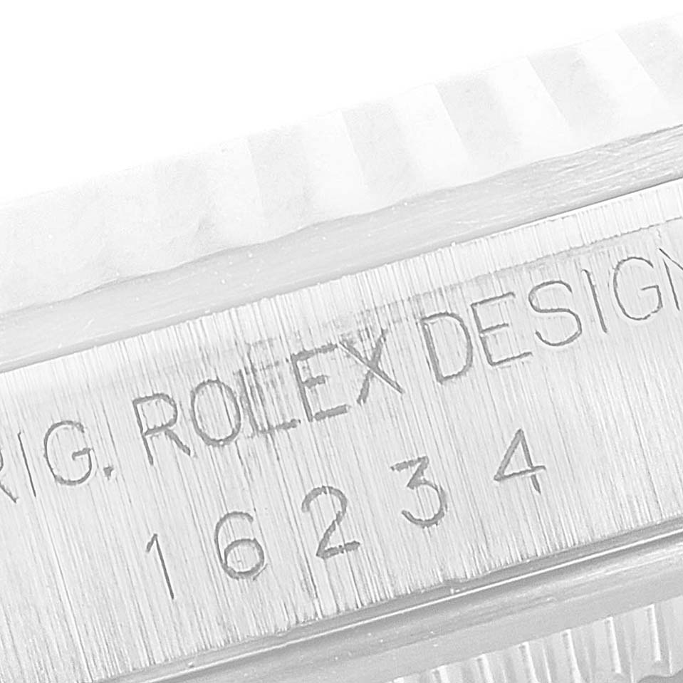 This image shows a close-up of the serial number and "ROLEX" engraving on a Rolex Datejust 16234 Men's Stainless Steel Pink Dial 16234 Men's Stainless Steel Pink Dial model.