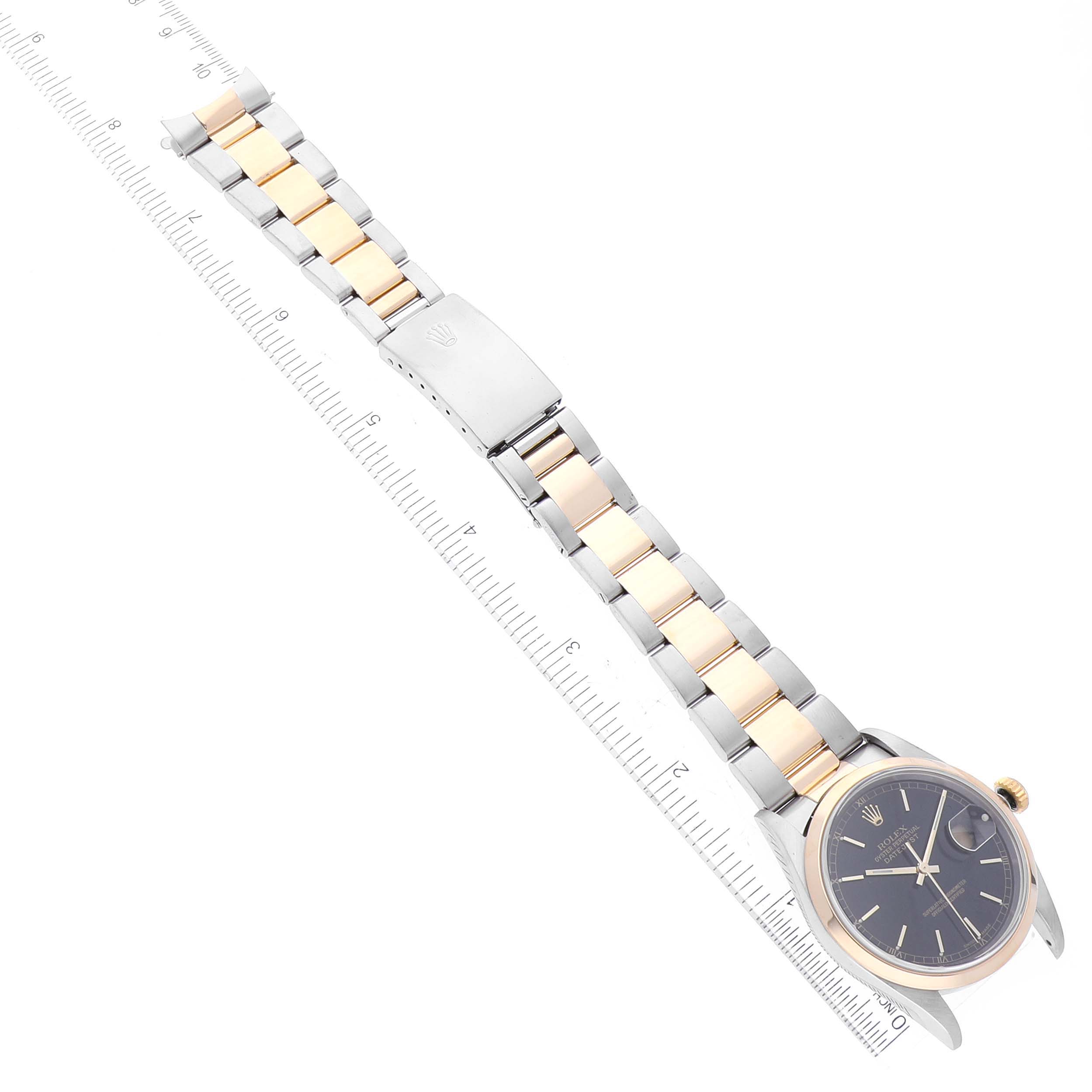 This image shows a Rolex Datejust 16203 Men's Steel and Gold (two tone) Black Dial 16203 Men's Steel and Gold (two tone) Black Dial watch from an overhead angle, highlighting the bracelet, clasp, and face.