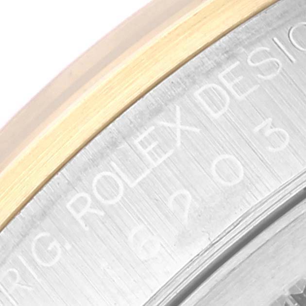 This close-up image shows part of the case back engraving and bezel of a Rolex Datejust 16203 Men's Steel and Gold (two tone) Black Dial 16203 Men's Steel and Gold (two tone) Black Dial watch.