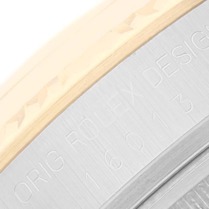 This close-up image of the Rolex Datejust 16013 Men's Steel and Gold (two tone) Champagne Dial 16013 Men's Steel and Gold (two tone) Champagne Dial model focuses on the case side, showing the engraved text and part of the bezel.