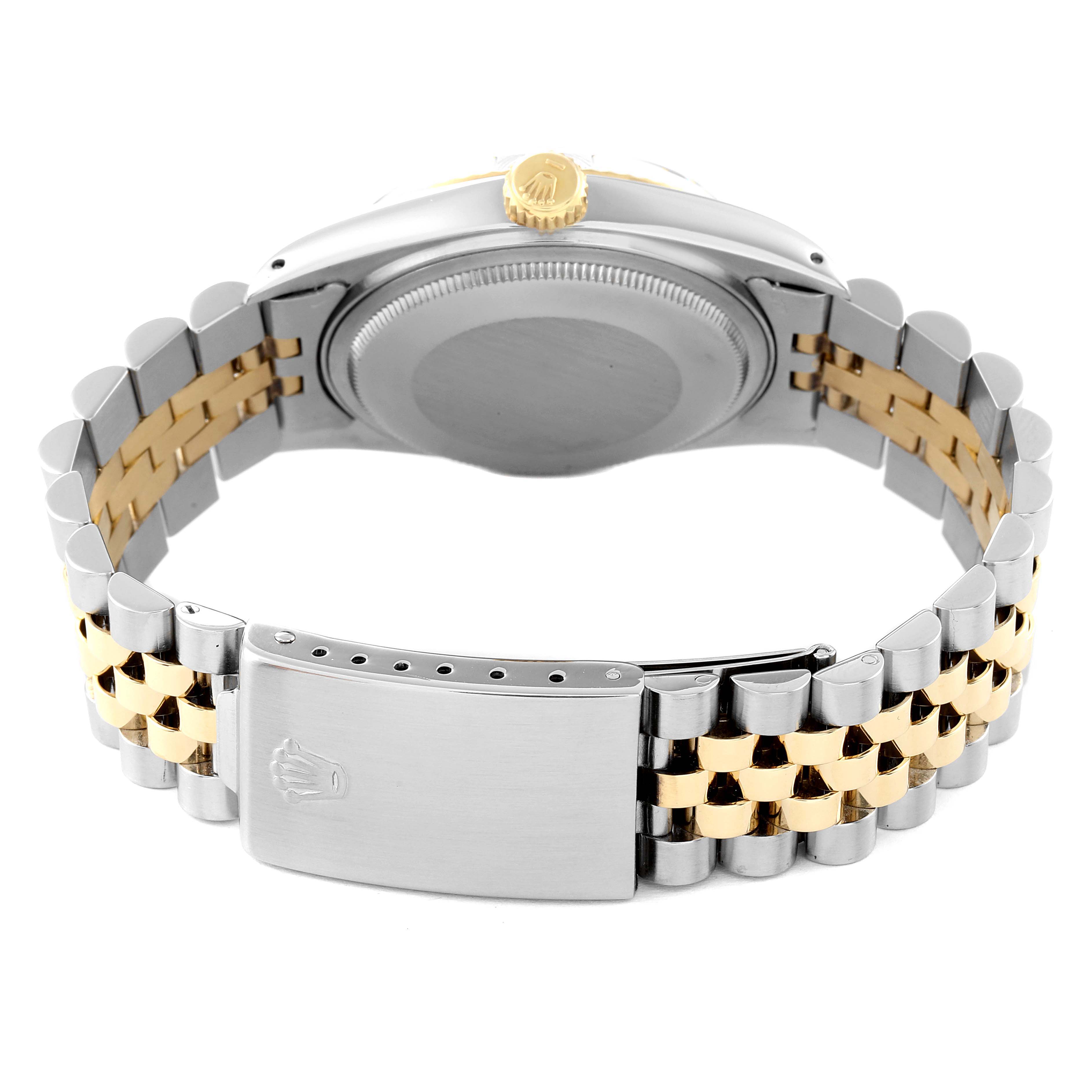 The image shows the back of the Rolex Vintage Collection 16013 Men
s Steel and Gold (two tone) Champagne Dial 16013 Men
s Steel and Gold (two tone) Champagne Dial watch, highlighting its case, winding crown, and two-tone bracelet with clasp.