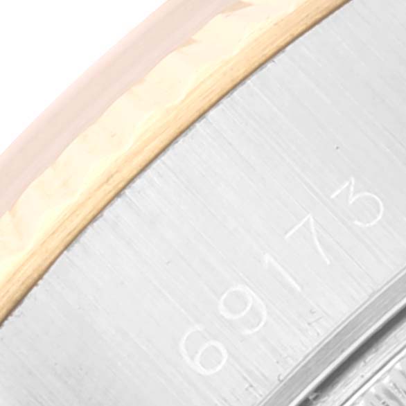 This is a close-up angle showing part of the bezel and serial number of a Rolex Datejust 69173 Women's Steel and Gold (two tone) Black Dial 69173 Women's Steel and Gold (two tone) Black Dial watch.