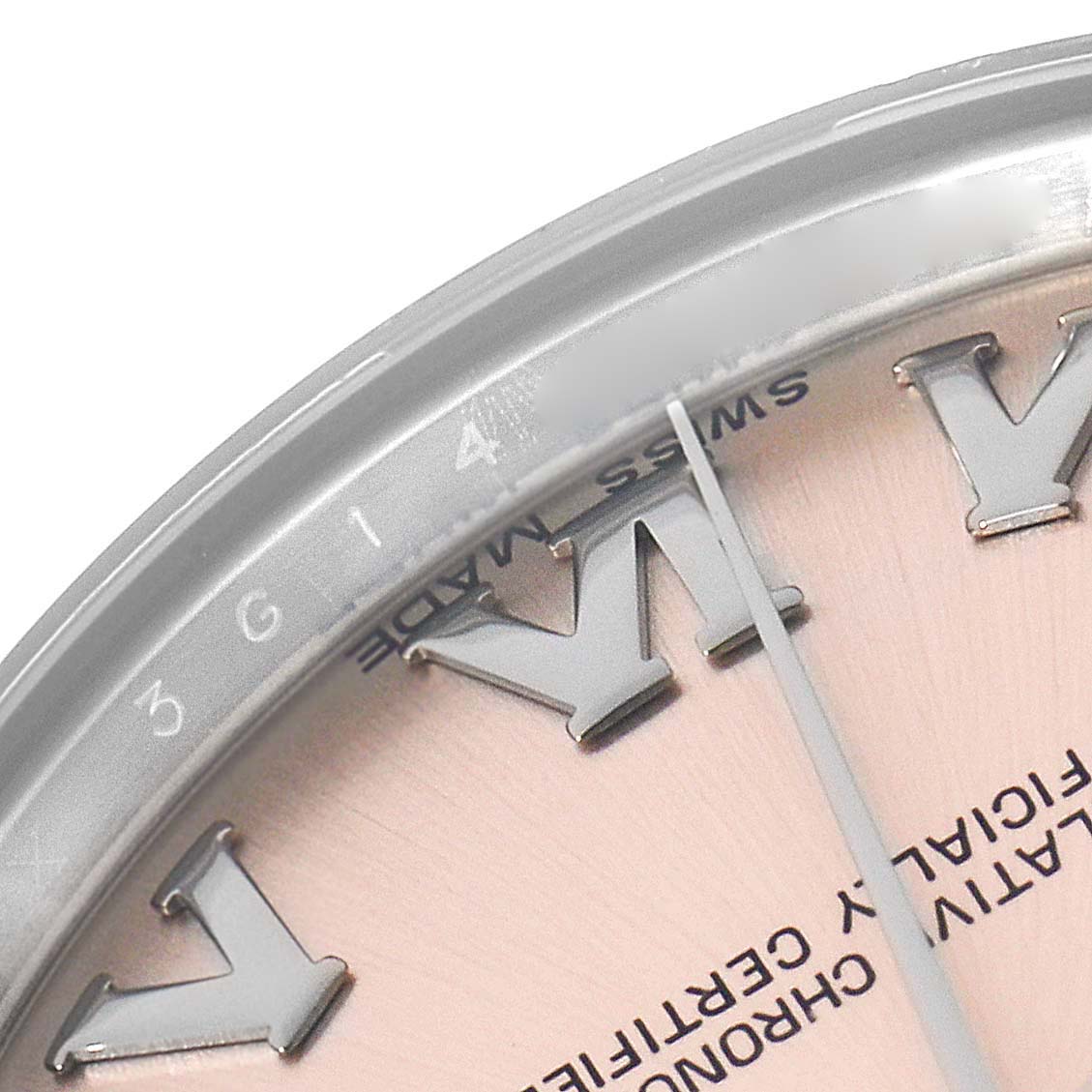 This close-up of the Rolex Datejust 178240 Women's Stainless Steel Pink Dial watch shows part of the dial, bezel, and Roman numerals at an angled view.
