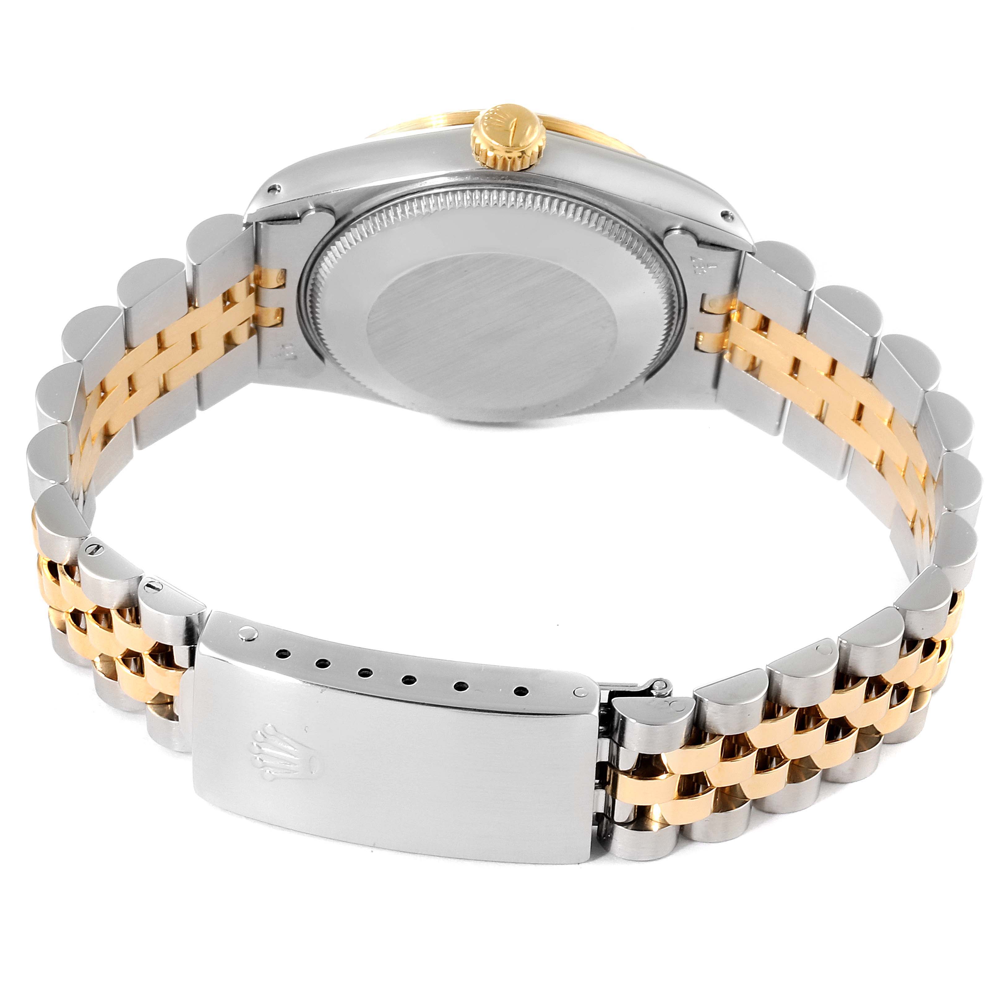 The image shows the back side of a Rolex Mid-Size 68273 Women's Steel and Gold (two tone) Blue Dial 68273 Women's Steel and Gold (two tone) Blue Dial watch with its clasp, case back, and two-tone bracelet.