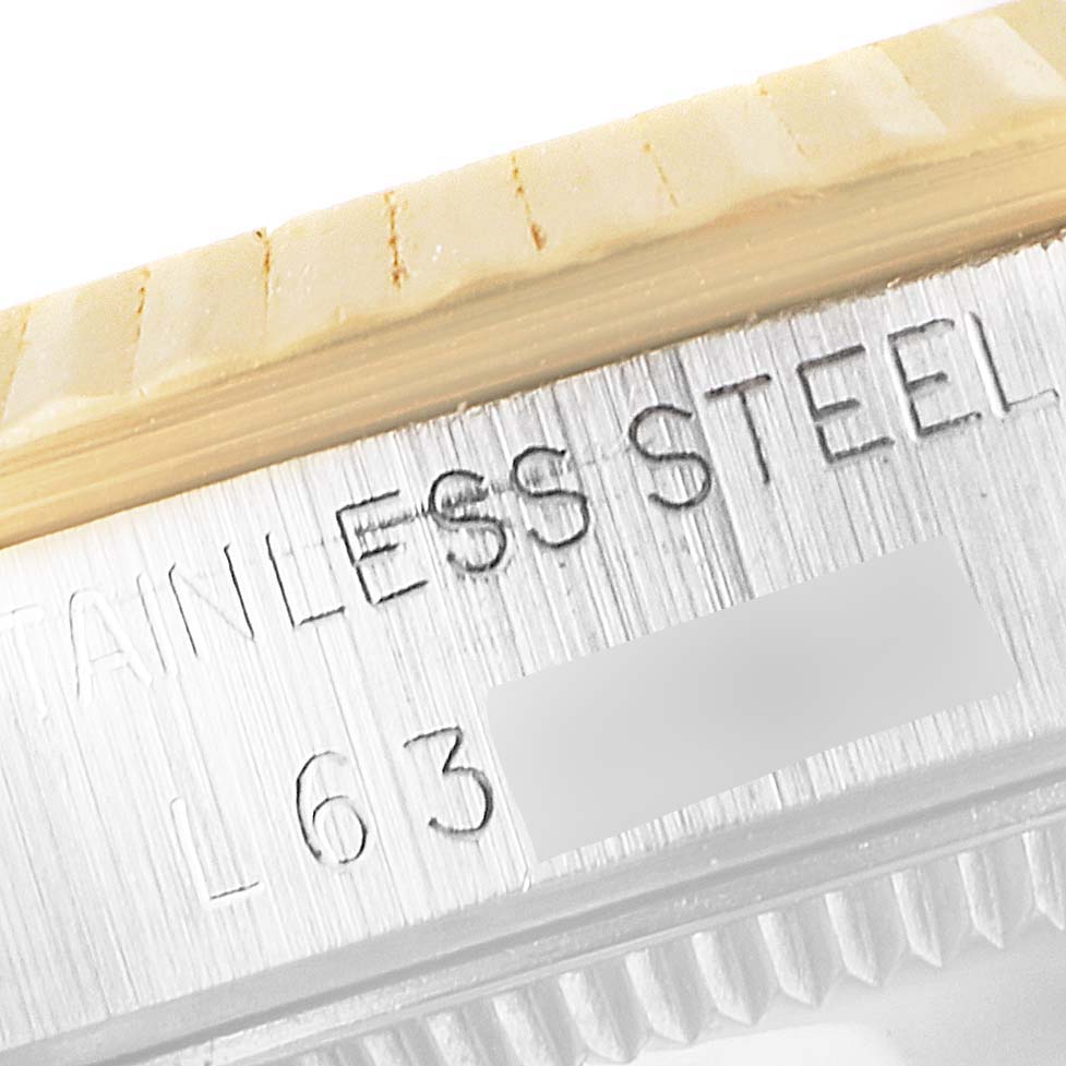 The image shows a close-up of the bezel and case side of a Rolex Mid-Size 68273 Women's Steel and Gold (two tone) Blue Dial 68273 Women's Steel and Gold (two tone) Blue Dial watch, focusing on the "STAINLESS STEEL" engraving.