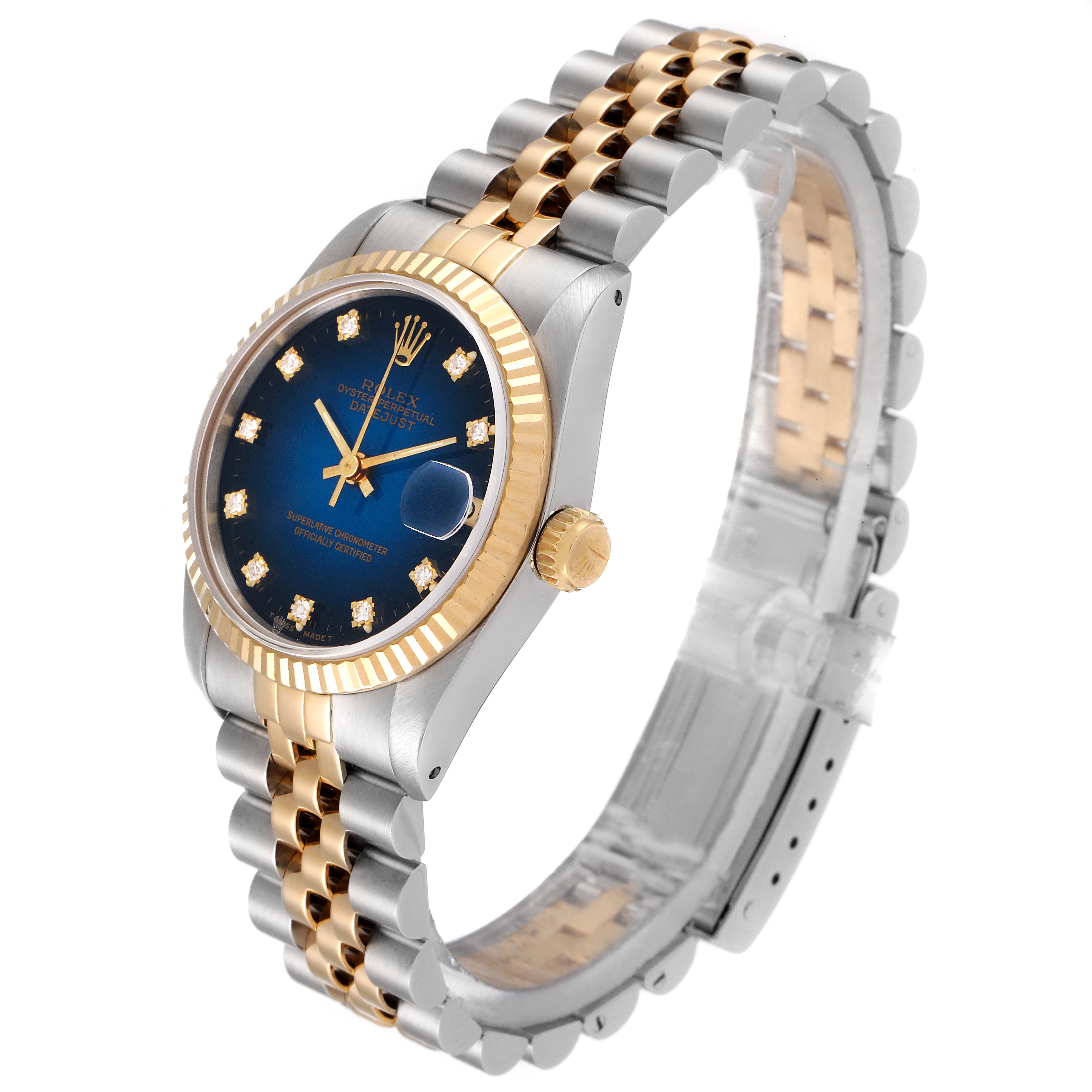 The image shows a side and partial top view of a Rolex Mid-Size 68273 Women's Steel and Gold (two tone) Blue Dial 68273 Women's Steel and Gold (two tone) Blue Dial watch, highlighting its two-tone bracelet, blue dial, and gold bezel.