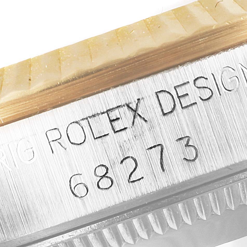 This image shows a close-up of the serial number engraving on the side of a Mid-Size Rolex watch case.