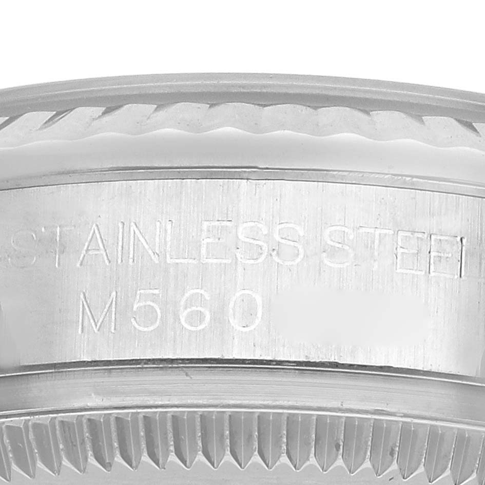 The image shows the side view of a Rolex Datejust 178274 Women's Stainless Steel Silver Dial watch, focusing on the stainless steel case with engravings.